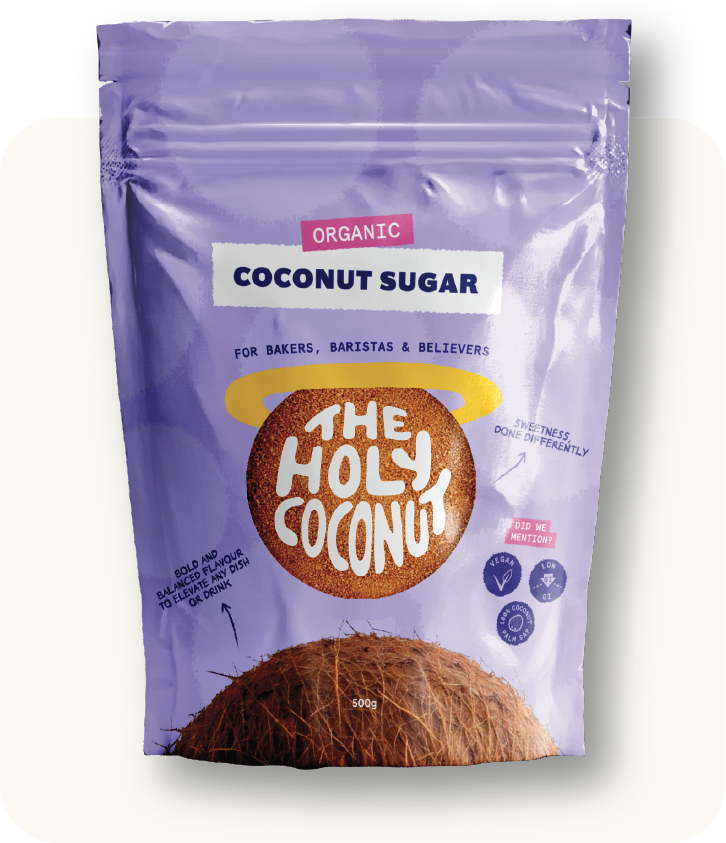A purple resealable bag of organic coconut sugar with branding that reads 'The Holy Coconut,' designed for bakers, baristas, and believers. The package features a picture of a coconut at the bottom and has icons indicating it is vegan, low GL, and sustainably sourced.