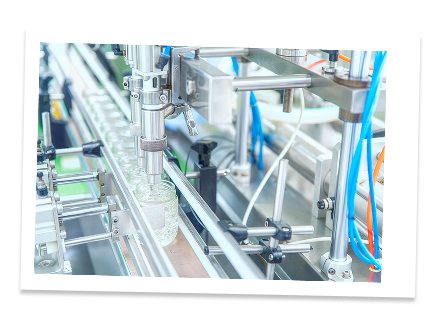 Automated manufacturing line with robotic arms, conveyor belts, and machinery in a factory setting.