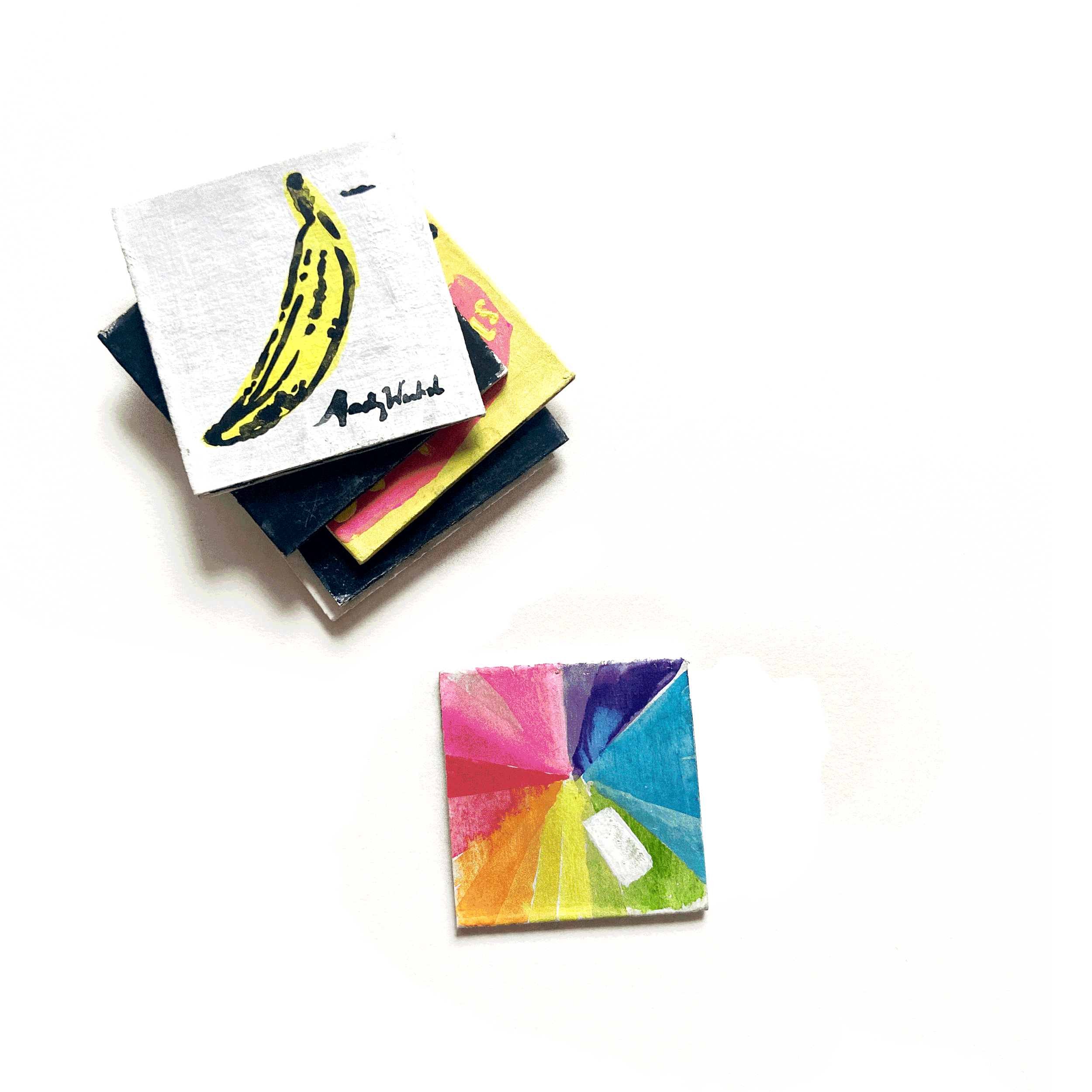 Colorful artwork with a prominent yellow banana and abstract multicolored patterns on paper