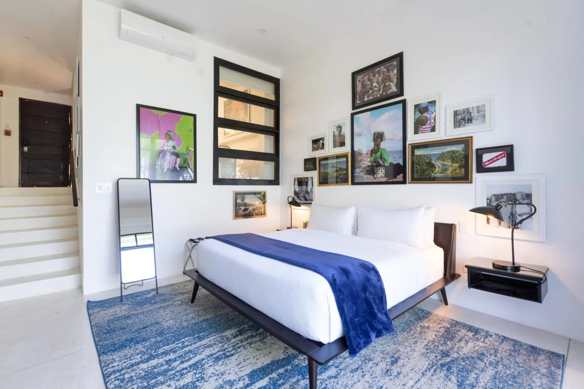 Bright private hotel room with bed and outdoor view.