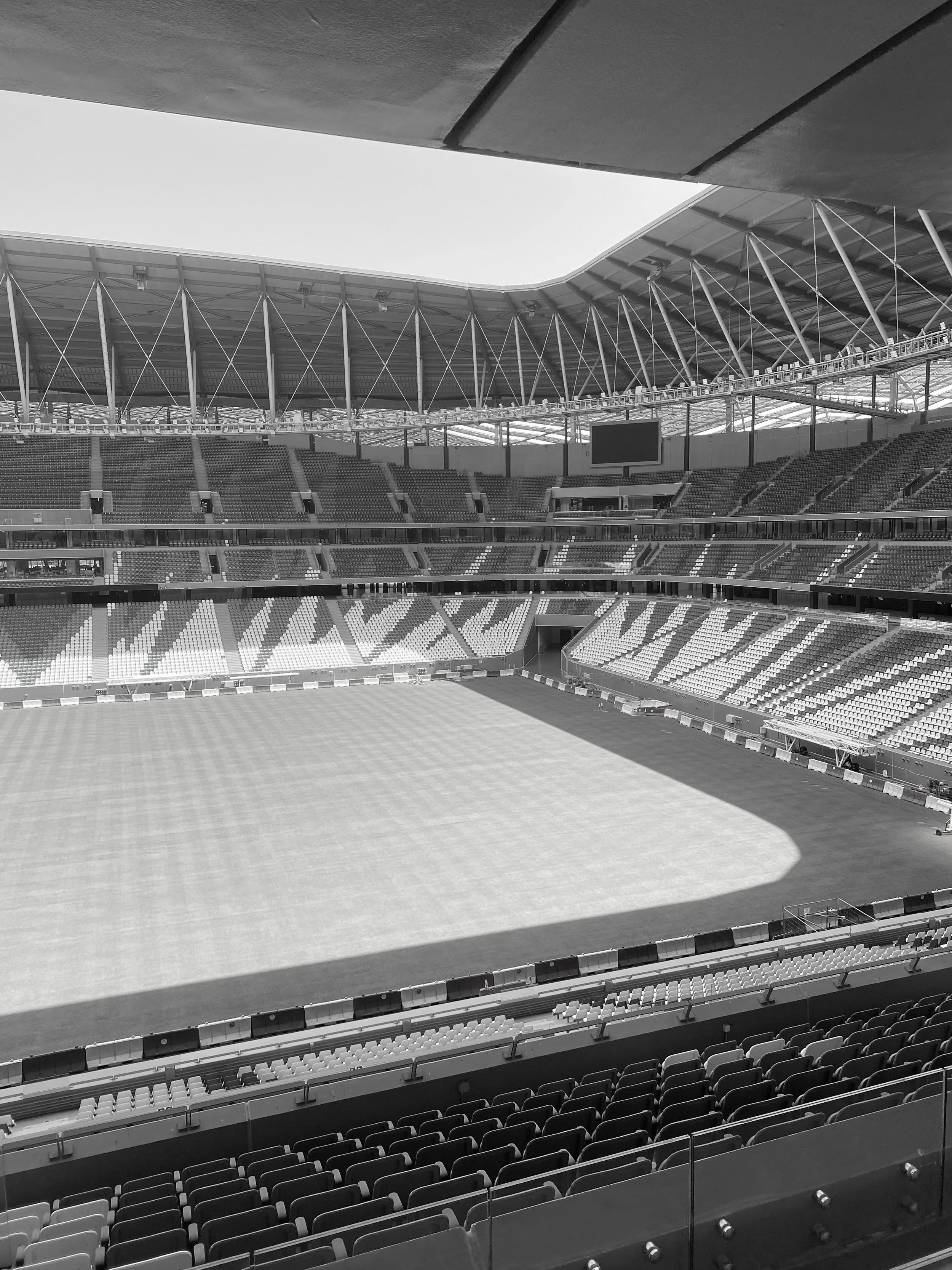 Empty sports stadium with a grass field and surrounding seating, viewed from the stands.
Education City Stadium. Doha, Qatar