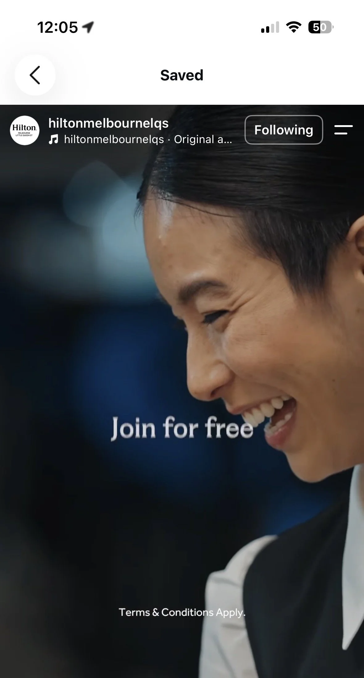 Screen showing a woman in a black blazer smiling with her eyes closed, promoting joining a service for free, with small text about terms and conditions at the bottom.