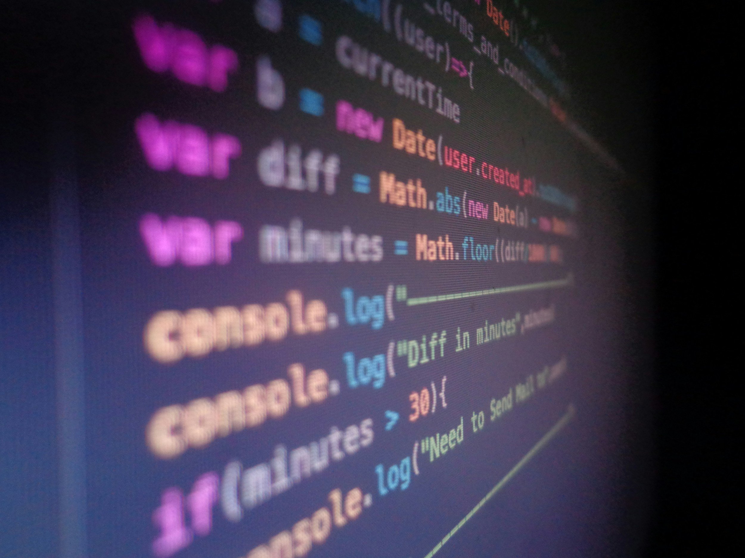 black computer screen showing coloured text code