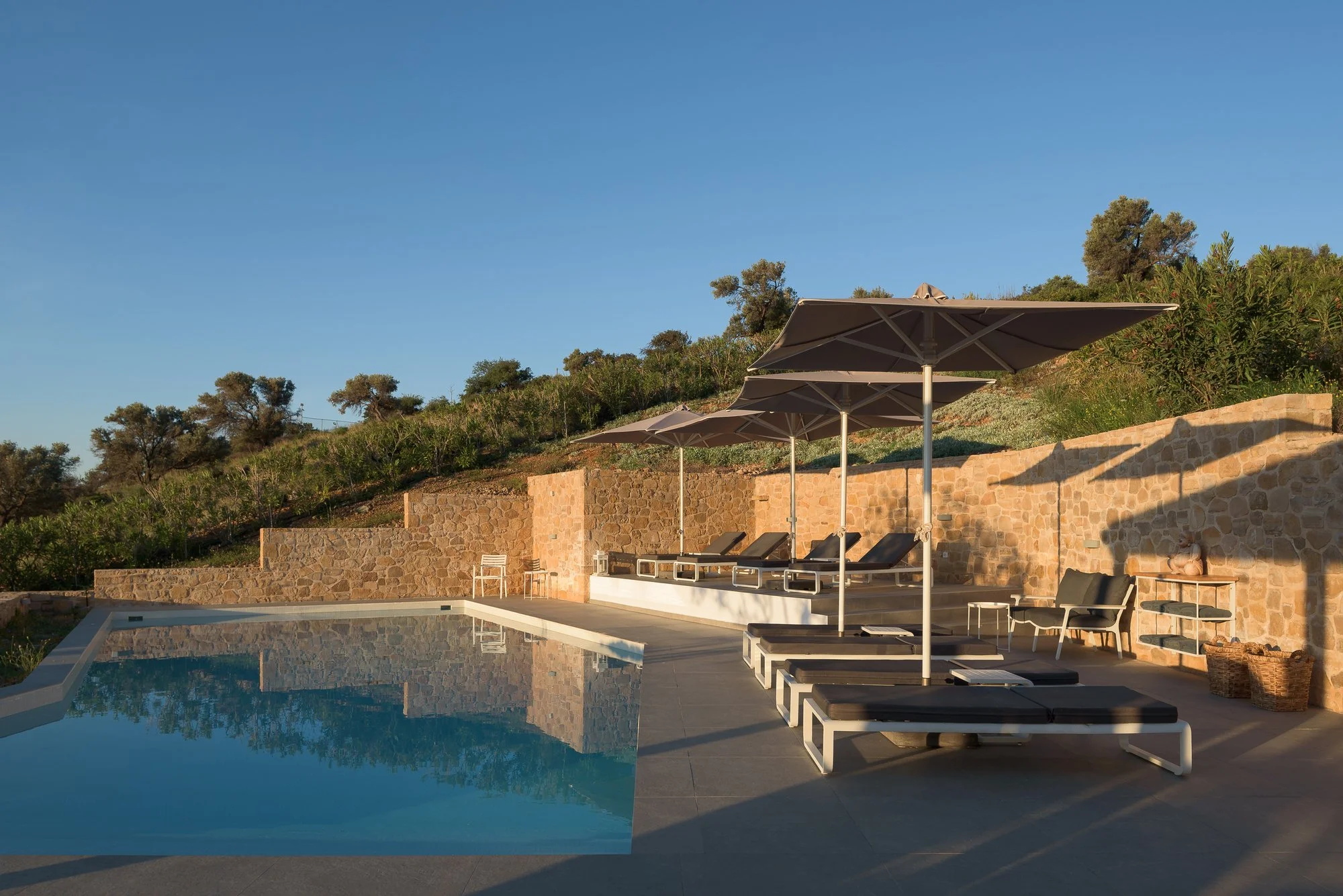 Infinity pool and sun loungers at Galini Breeze adults-only resort in Crete.