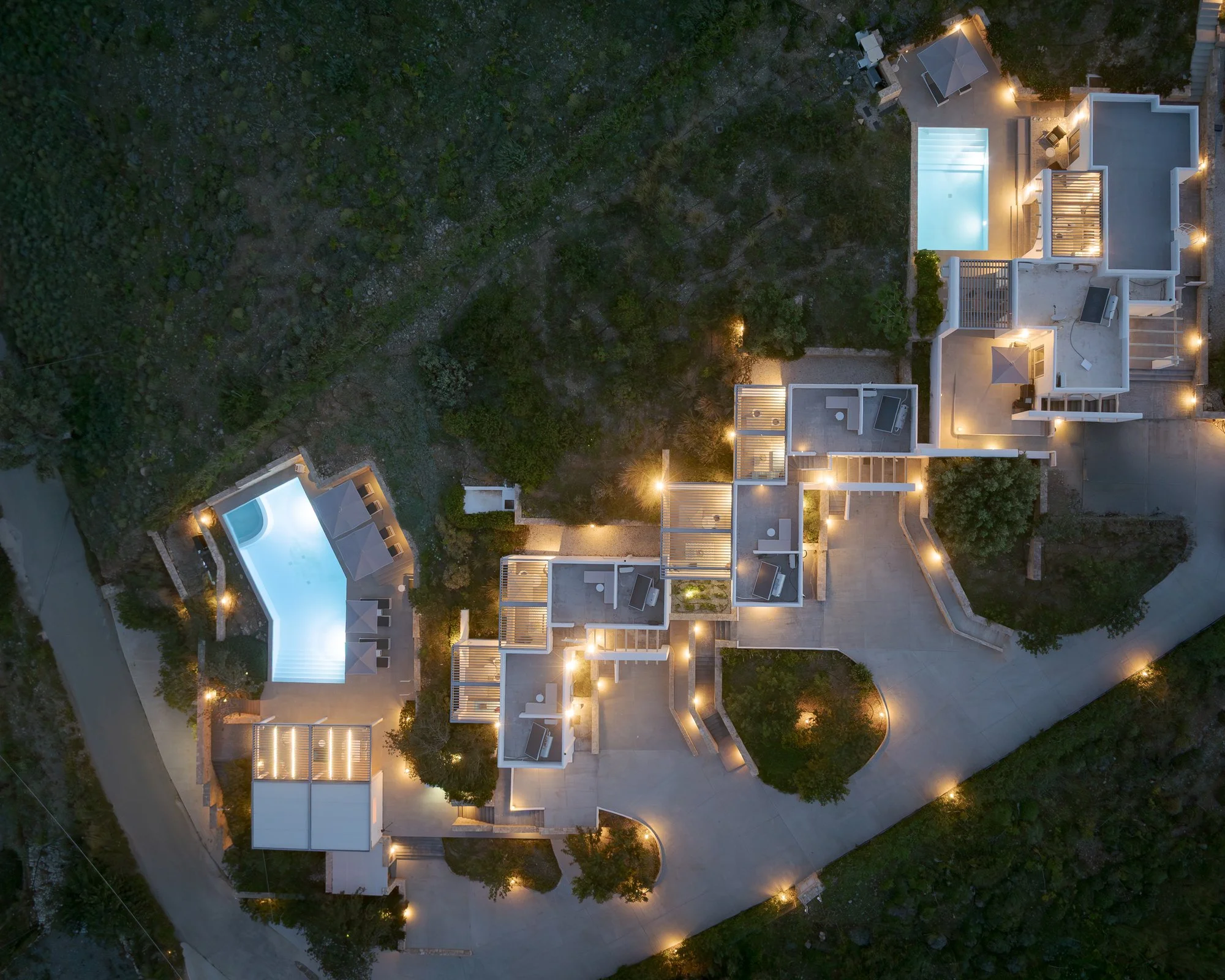 An aerial night view of Galini Breeze adults-only studios and heated pool in Agia Galini, Crete.