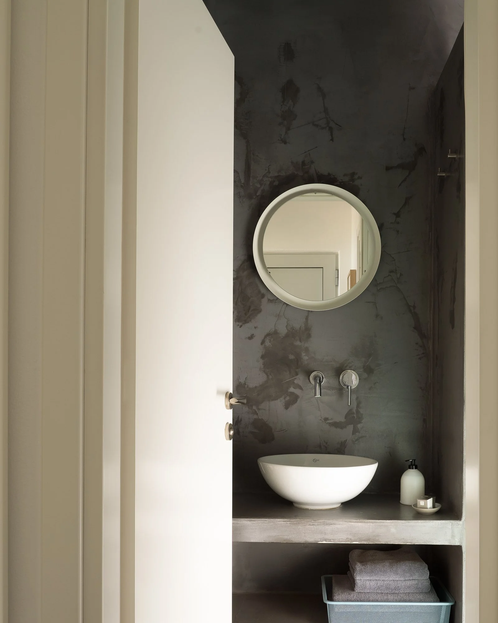 Minimalist luxury bathroom with floating vanity and boutique hotel aesthetics.