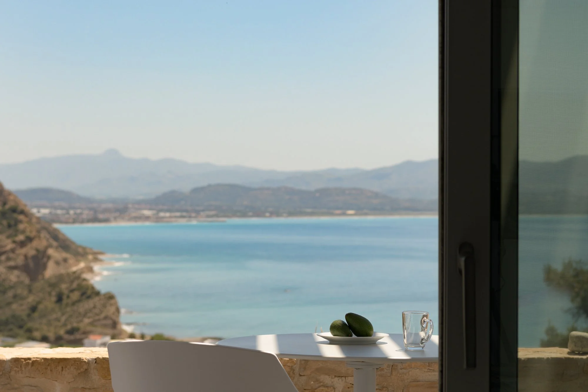 Boutique terrace seating area surrounded by natural Cretan landscape.