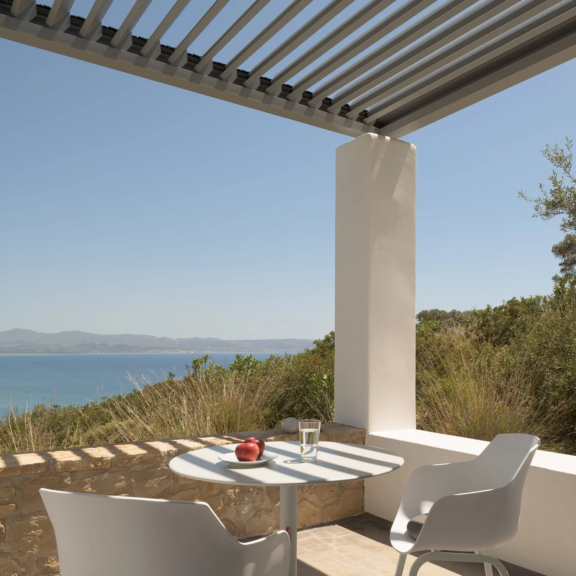 Minimalist white architectural terrace with boutique resort aesthetics in Agia Galini.