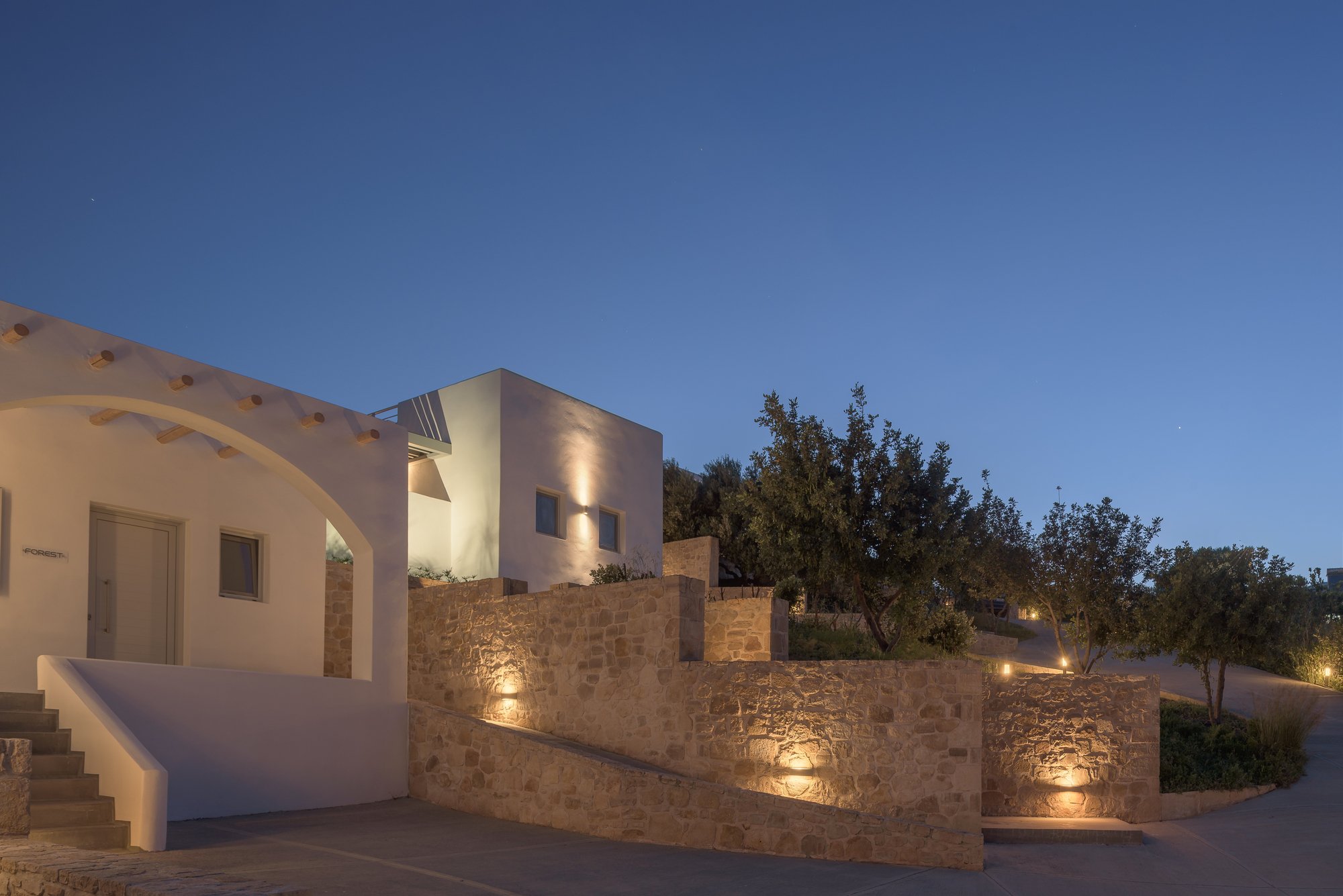 Galini Breeze adults-only studios illuminated at dusk in the hills of South Crete.