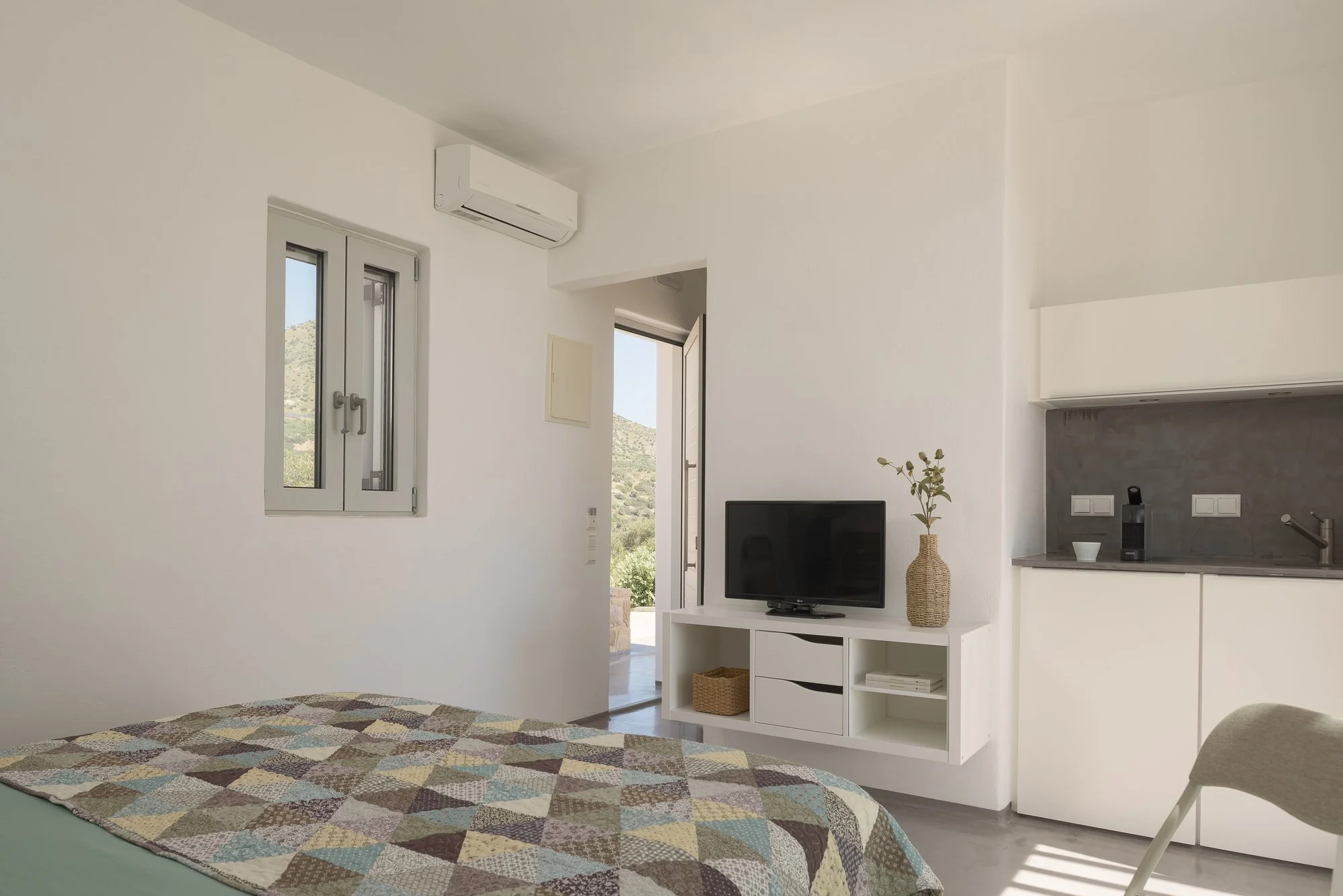 Modern suite in Agia Galini with panoramic mountain and sea views.