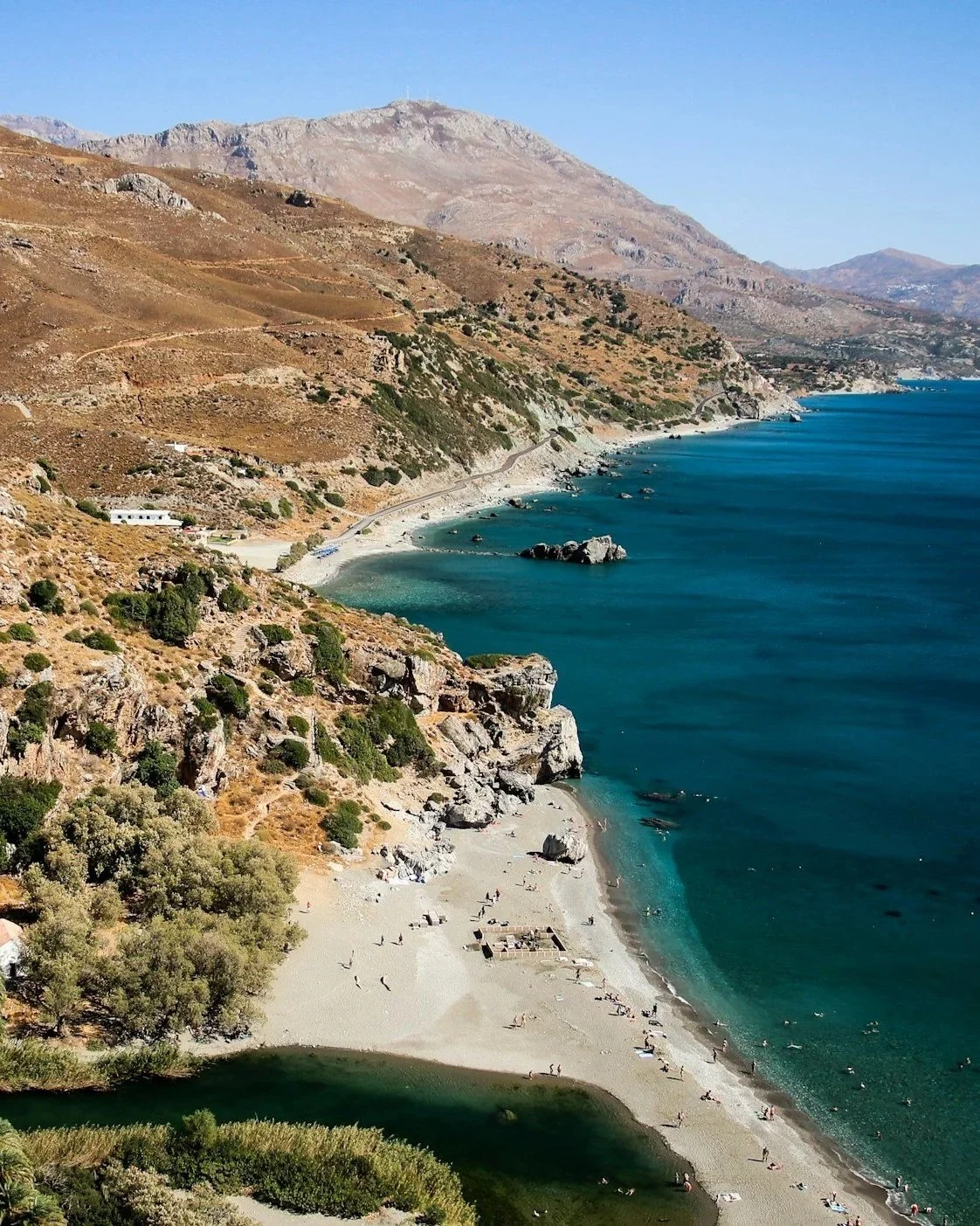 Dramatic South Crete coastline with turquoise Libyan Sea waters, mountain landscape and remote beach of Preveli