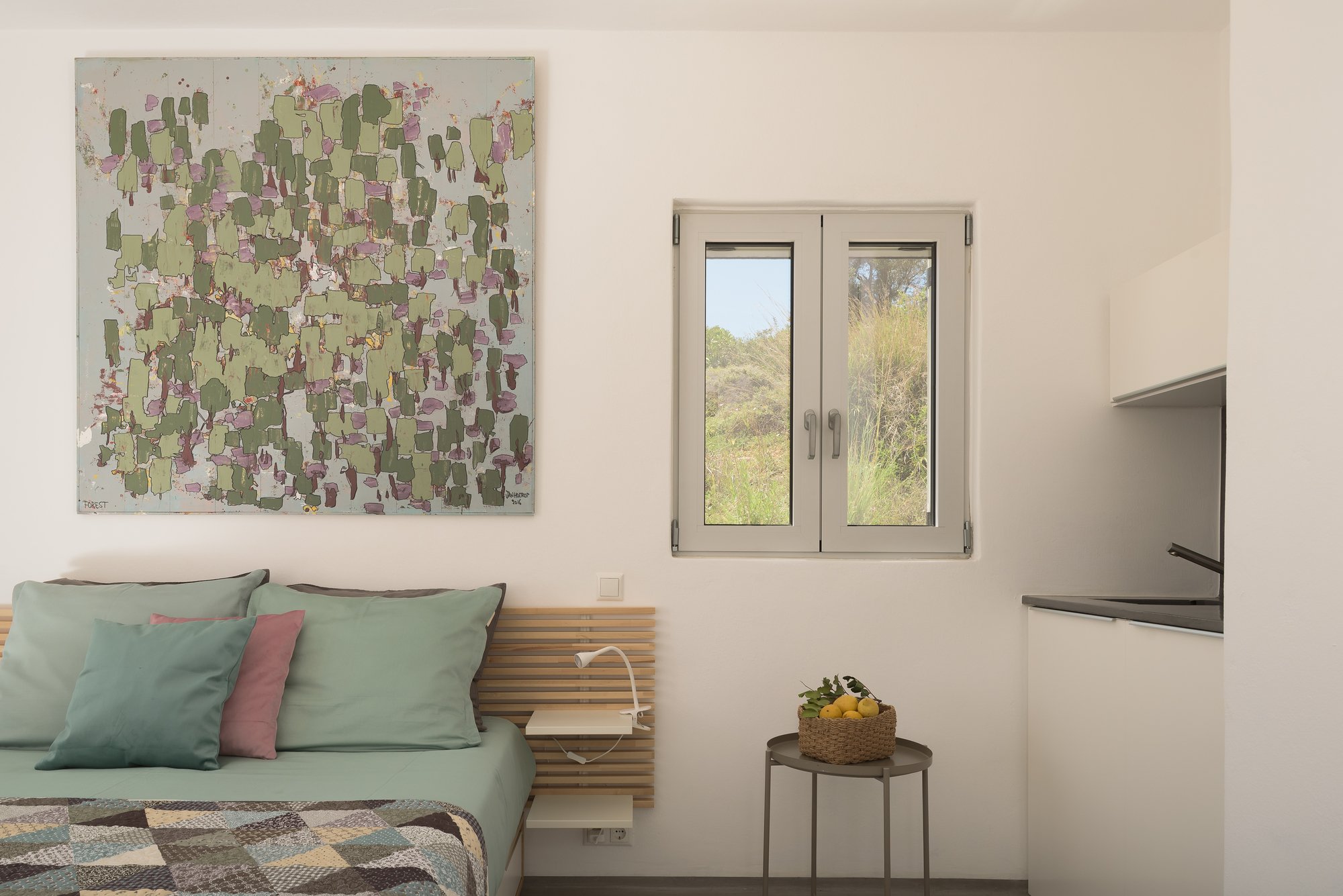 Contemporary minimalist suite with curated artwork and Mediterranean interior styling.