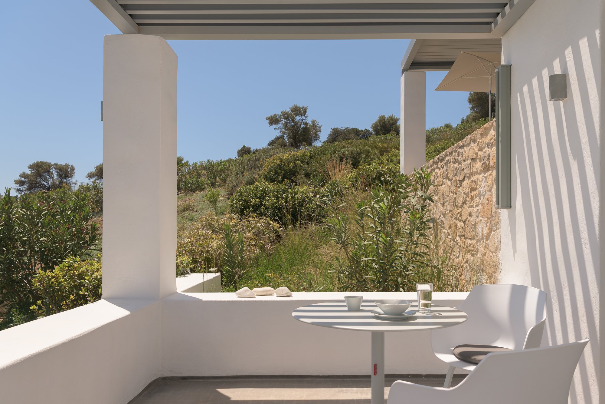 Private sun terrace surrounded by Mediterranean hillside scenery in South Crete.