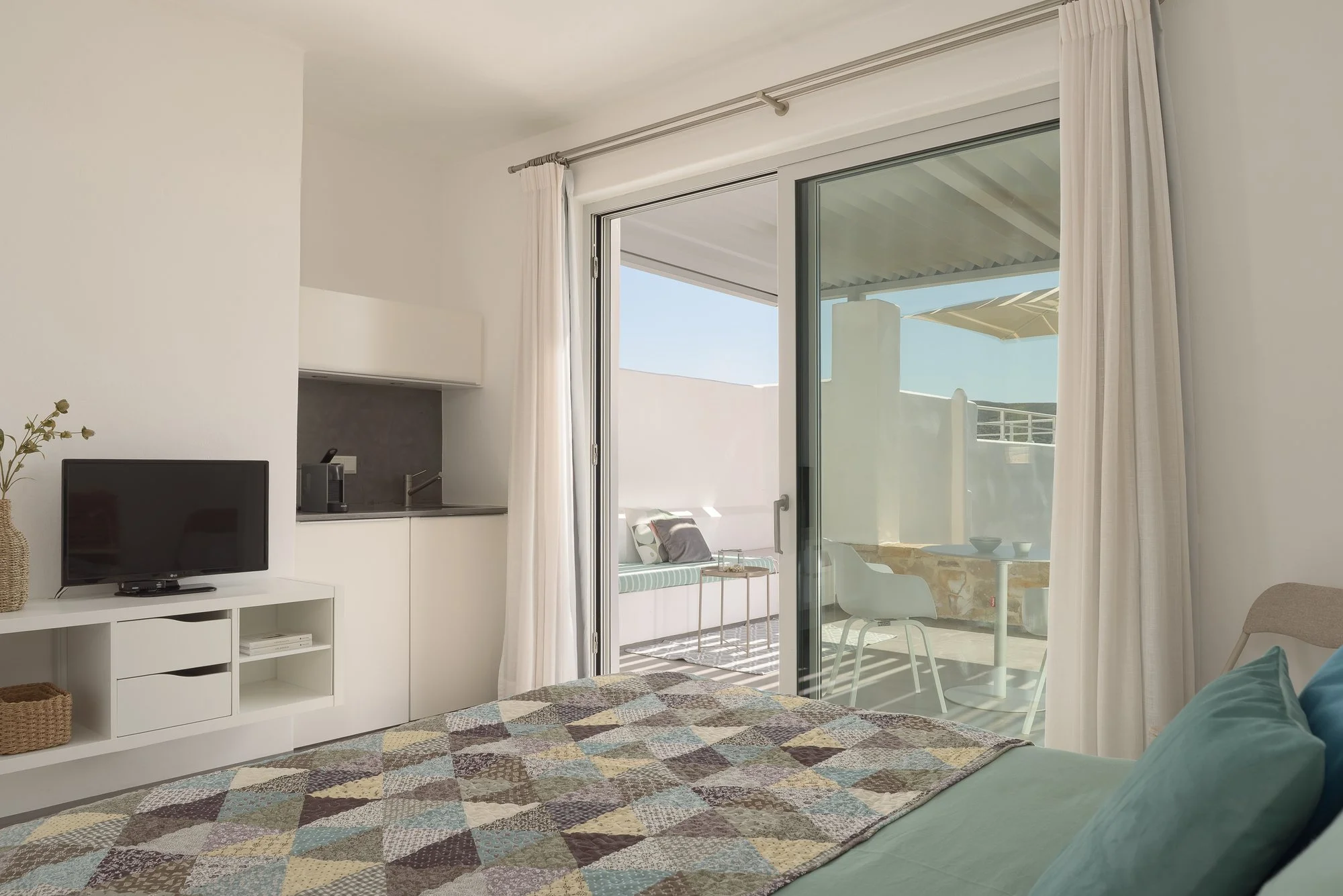 Bright minimalist living area at Galini Breeze with contemporary coastal interiors.