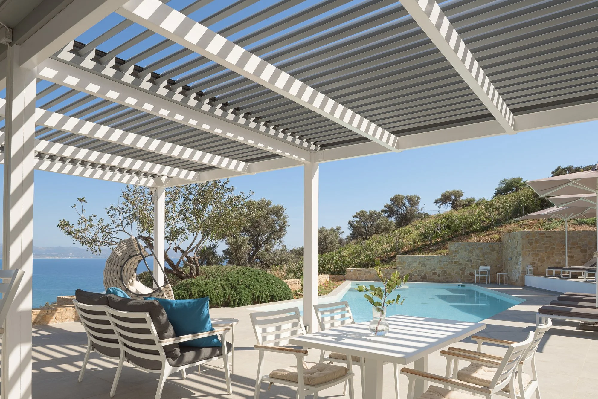 Shaded outdoor lounge and dining terrace at the Galini Breeze adults-only resort in Agia Galini, Crete