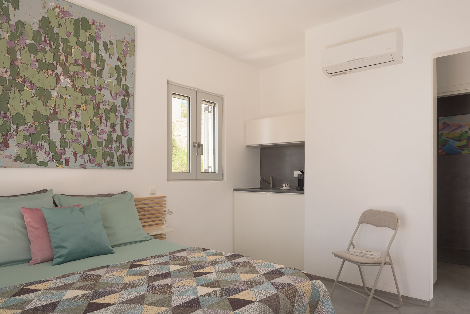 Modern boutique suite with artistic details and soft natural light in South Crete.