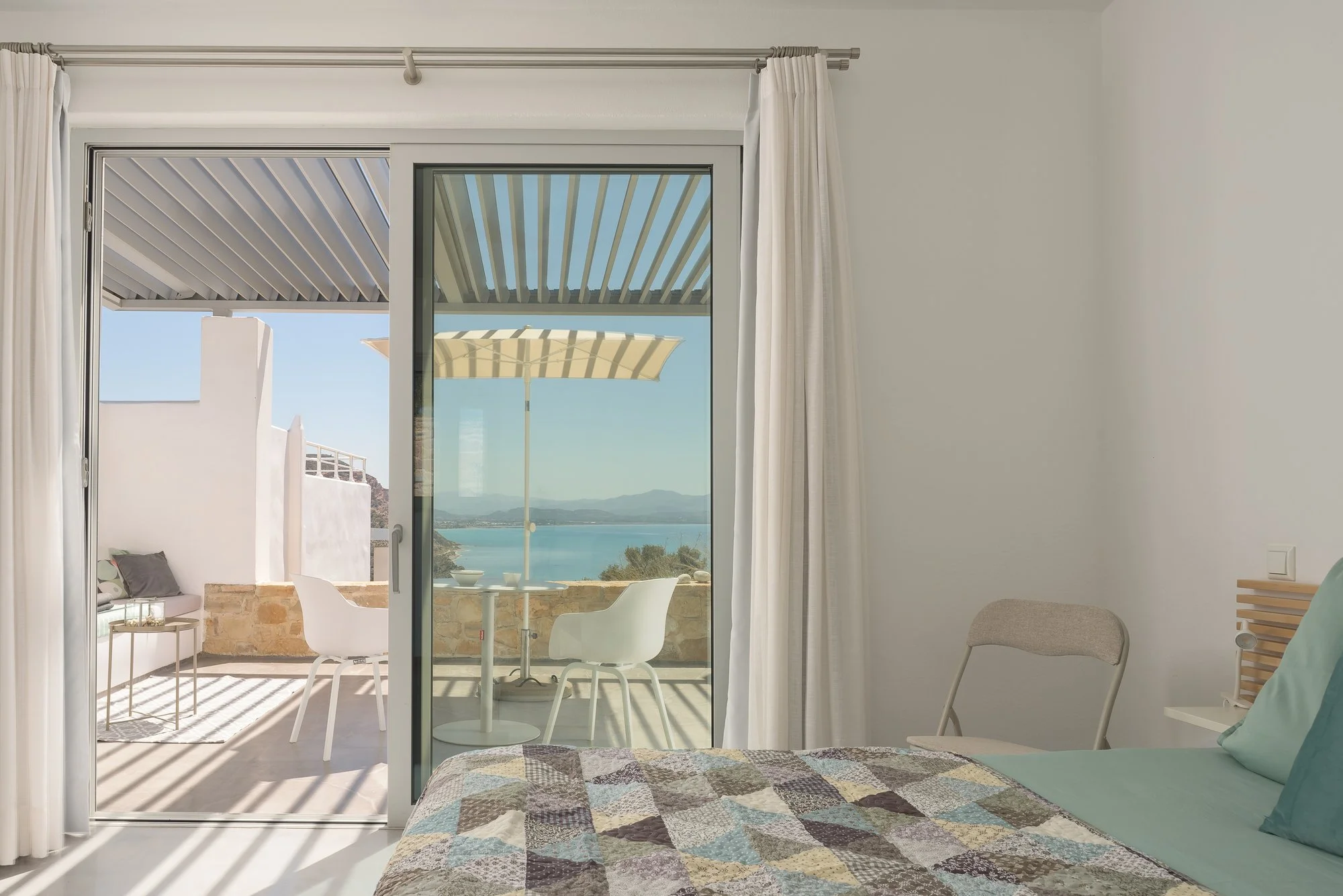 Boutique bedroom at Galini Breeze South Crete with curated Mediterranean décor.