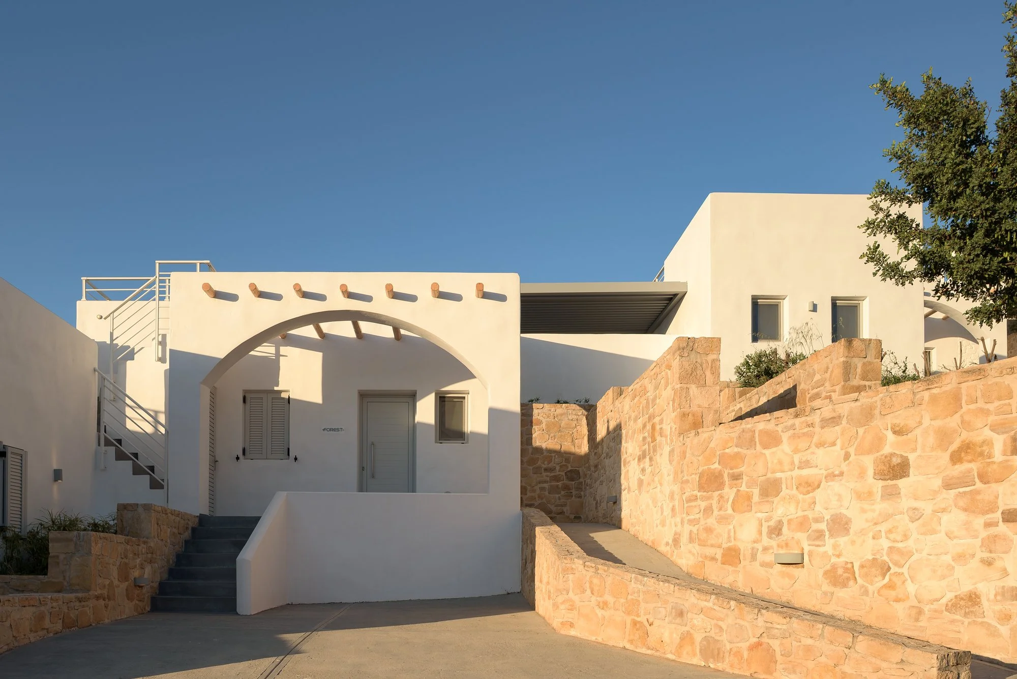 Elegant whitewashed entrance and stone walls at Galini Breeze near Agia Galini.