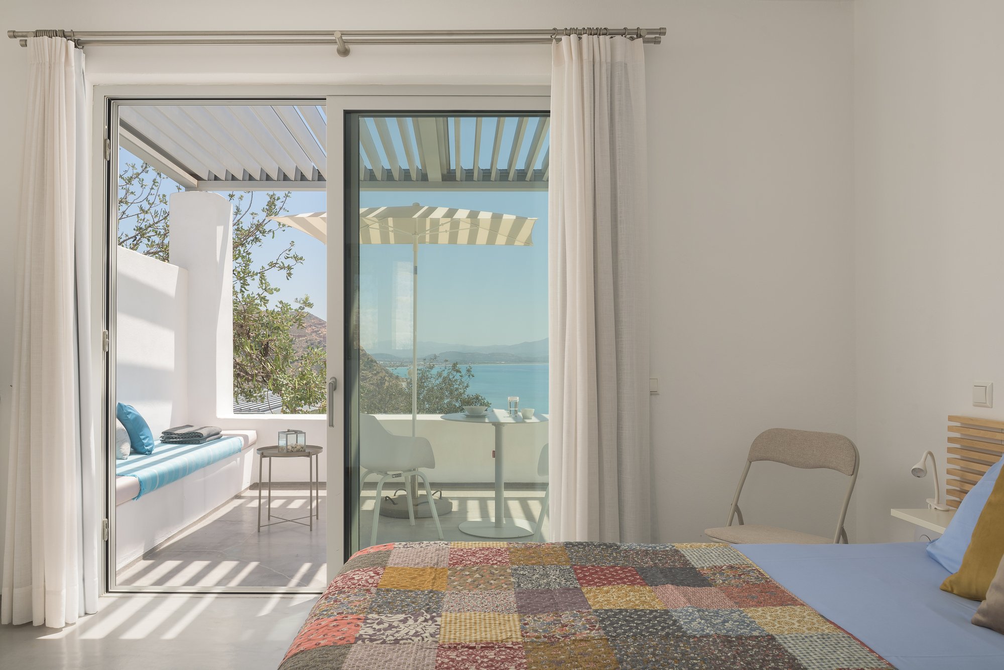 Private sea-view bedroom suite in Agia Galini with contemporary Mediterranean styling.