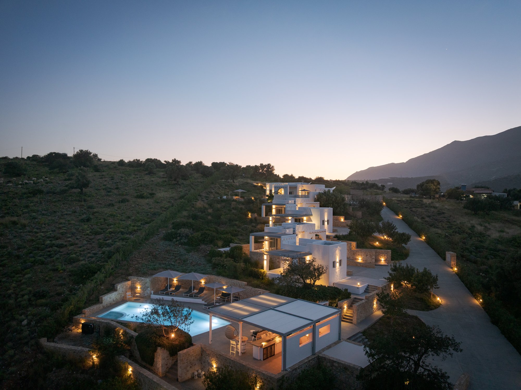Evening aerial view of Galini Breeze adults-only suites nestled in the hills above Agia Galini.
