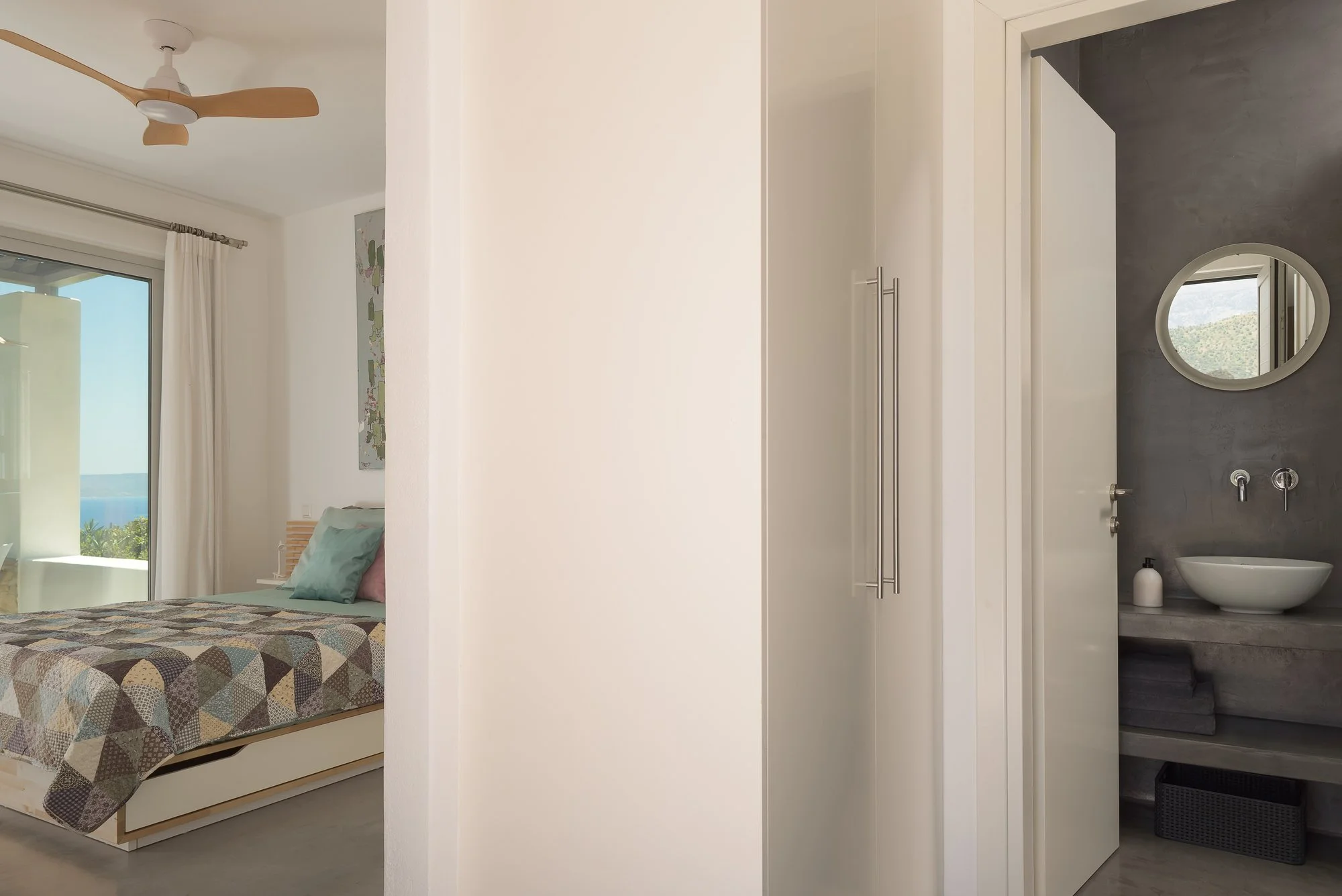 Boutique suite transition between bedroom and luxury bathroom.