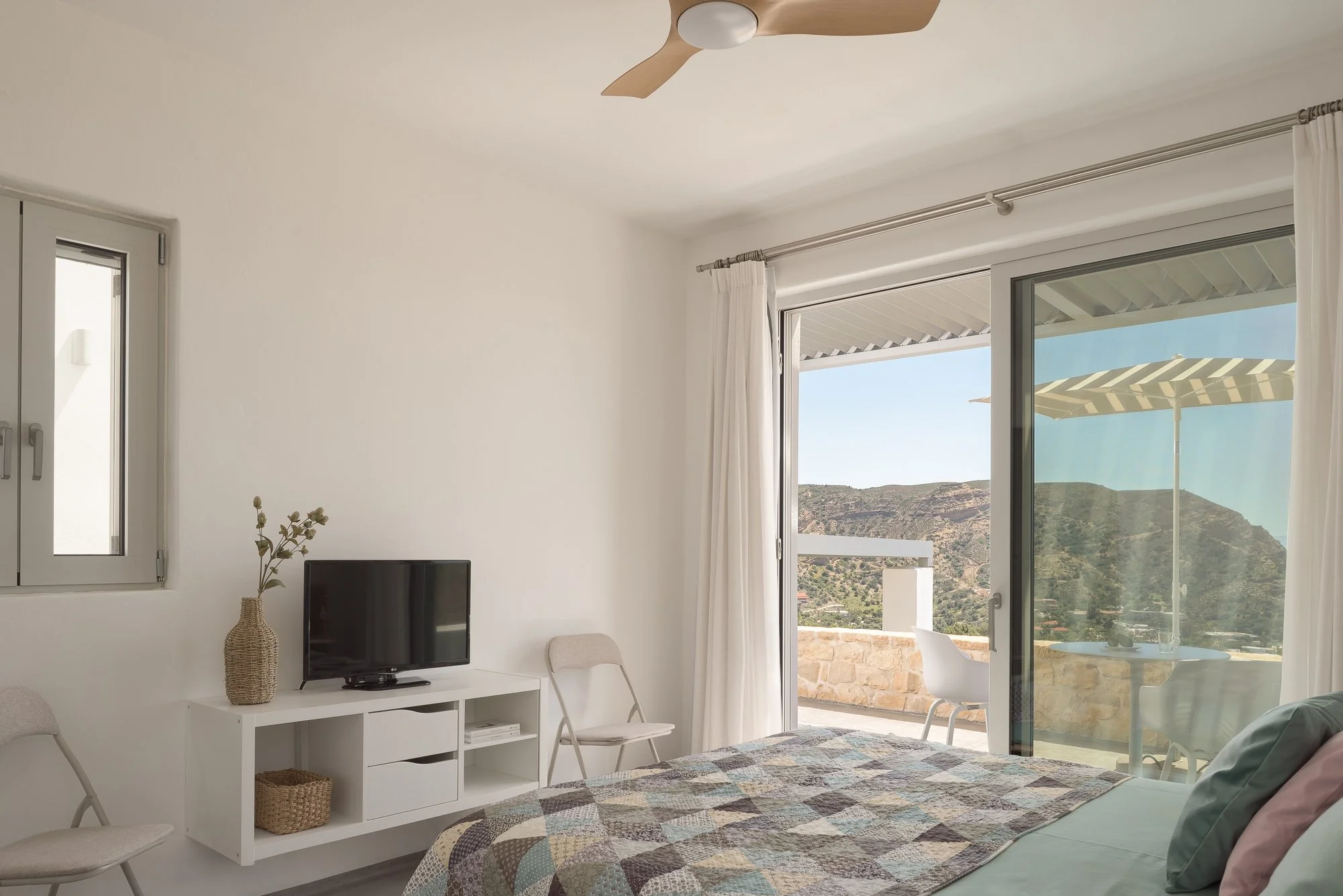 Bright sea-view living area with minimalist furnishings and boutique styling.