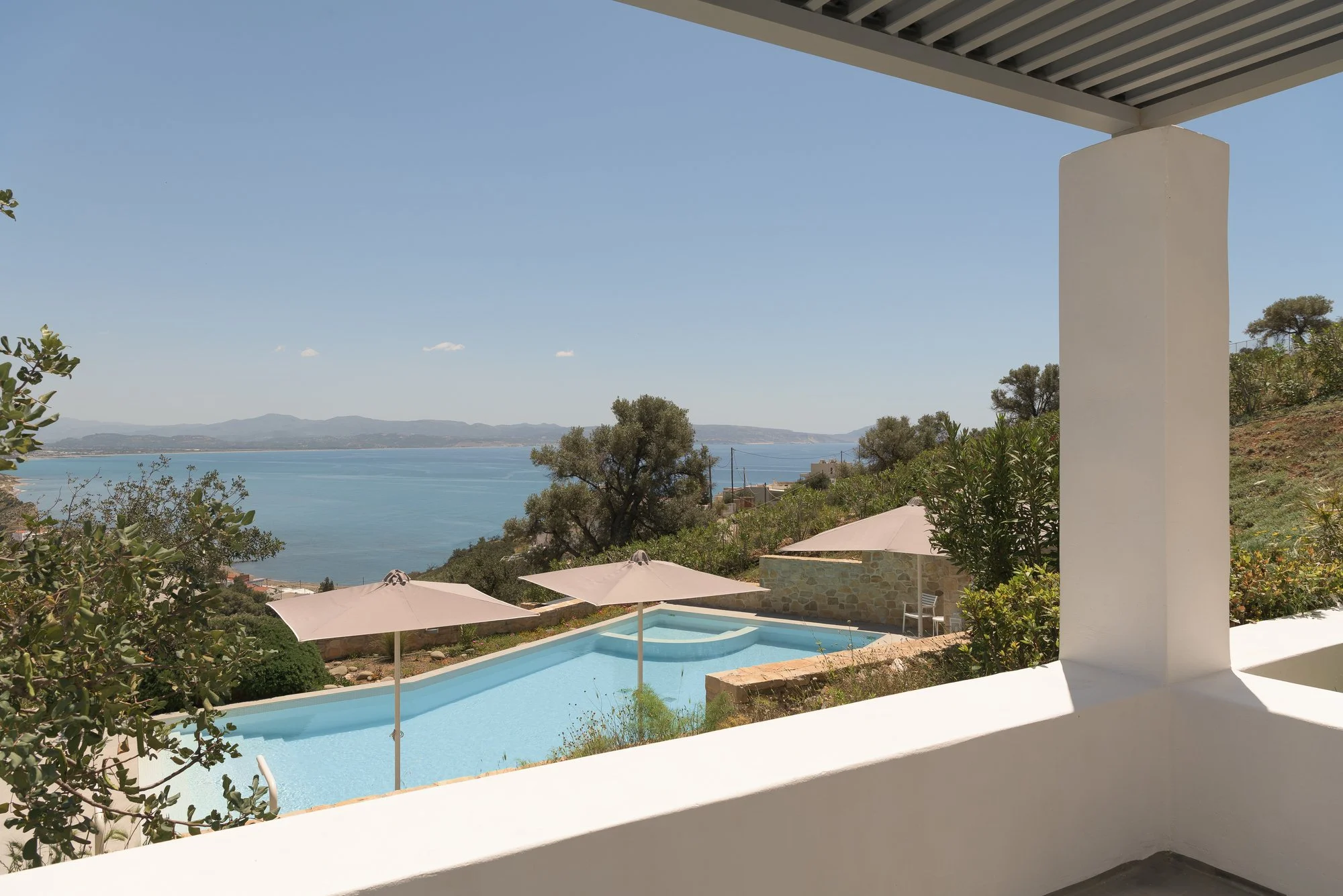 Pool and sea-view balcony at Galini Breeze overlooking the southern coast of Crete.