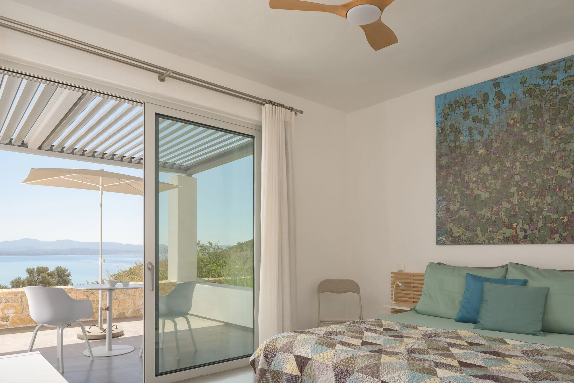Sea-view suite at Galini Breeze in Agia Galini with floor-to-ceiling sliding doors.