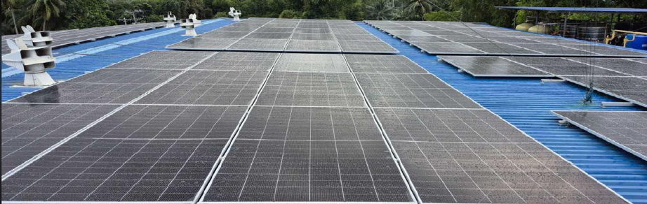 Large solar panels installed on a blue rooftop.