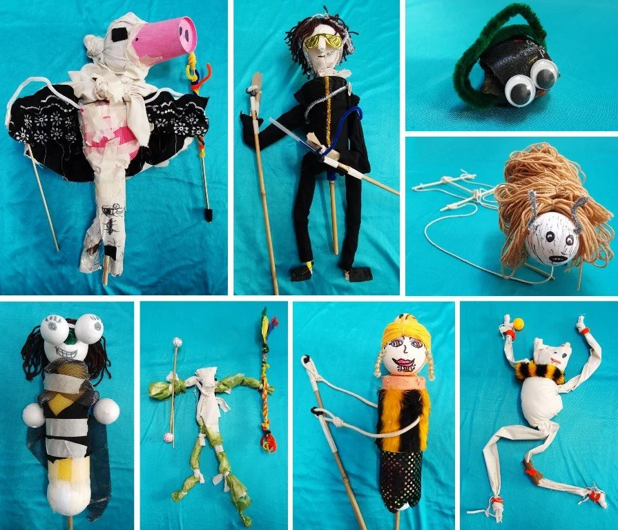 Collection of handmade puppets and puppetry improvisation tools against a blue background.