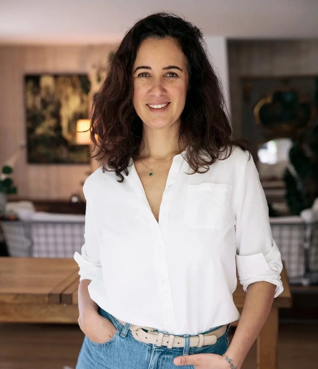 Laure Martin, praticienne narrative, dans son espace de travail entourée de livres et de plantes