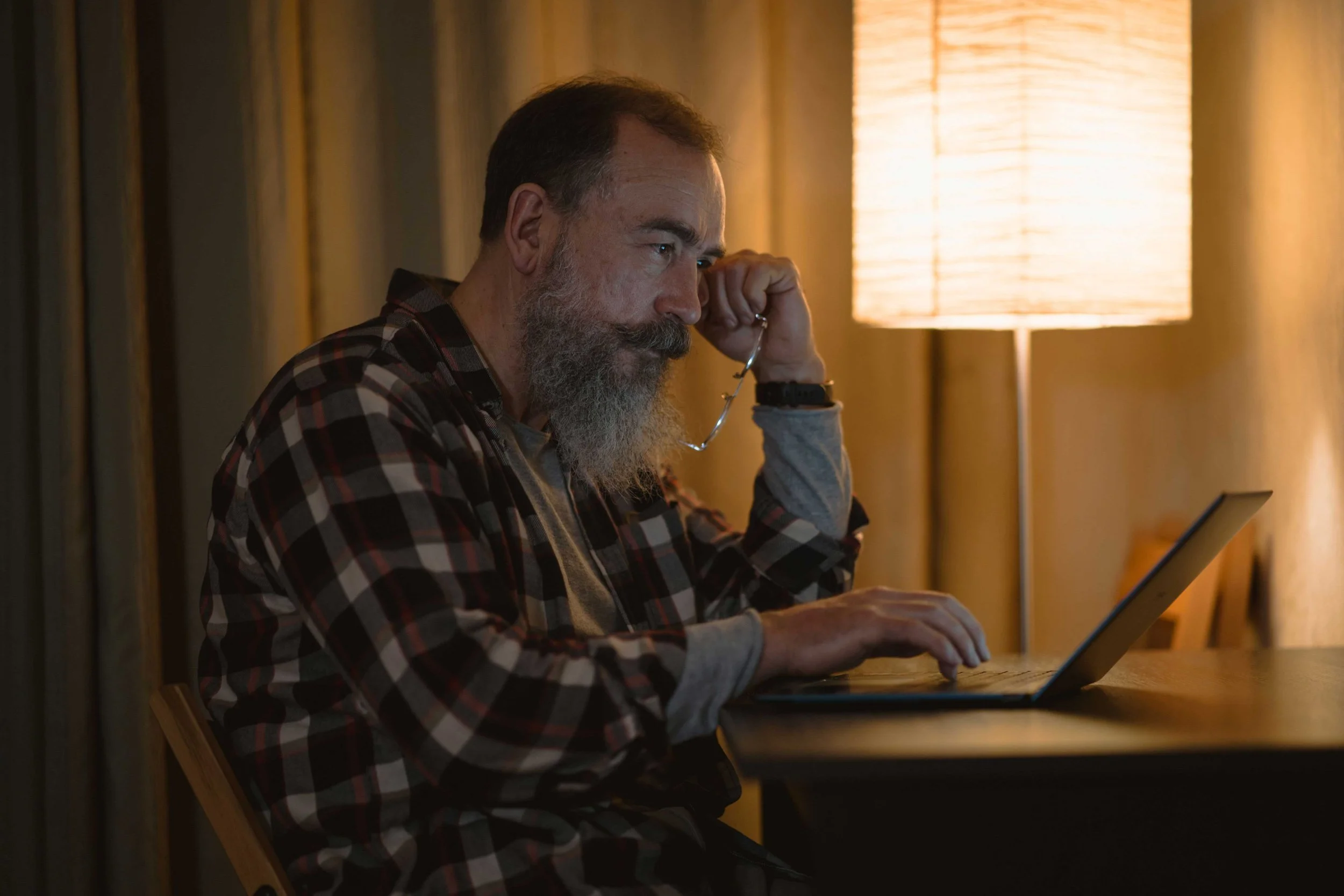 Person using a laptop at home for an online therapy session