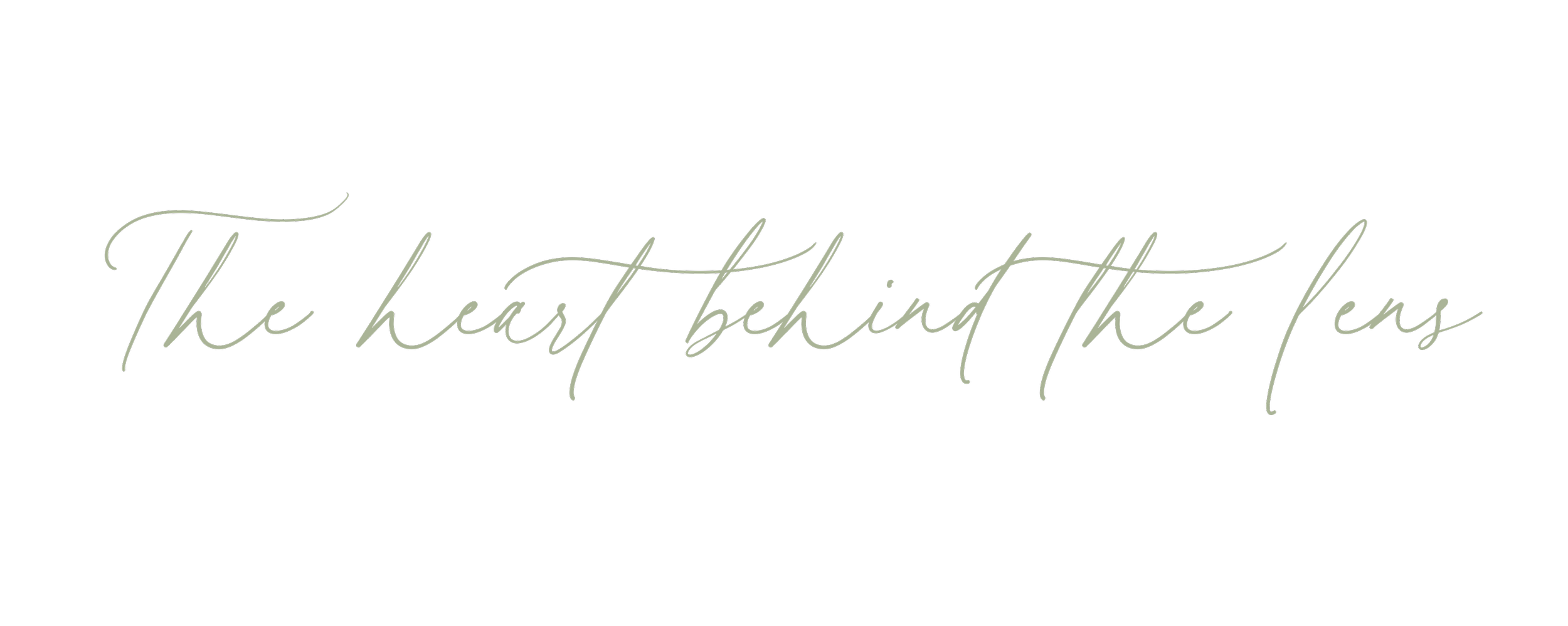 Elegant quote on a black background that reads 'The heart behind the lens' in cursive font.