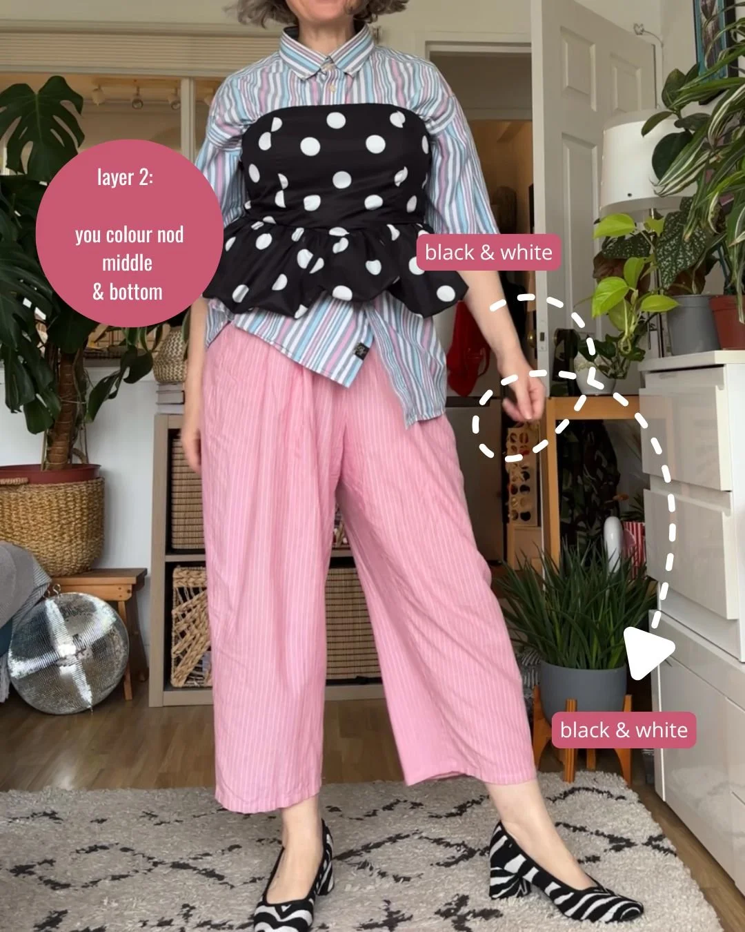 Colour nods, layer 2: black and white polka dot bustier top over striped shirt and pink trousers, the black and white picked up again in zebra print shoes.