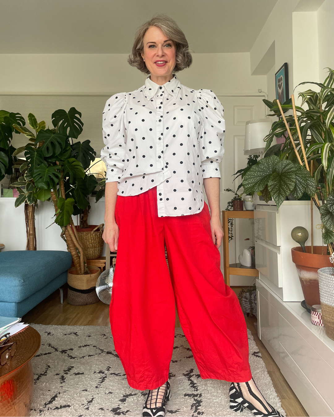Stripped back: white polka dot puff-sleeve shirt and red balloon trousers without the beret or accessories but with small styling tweaks