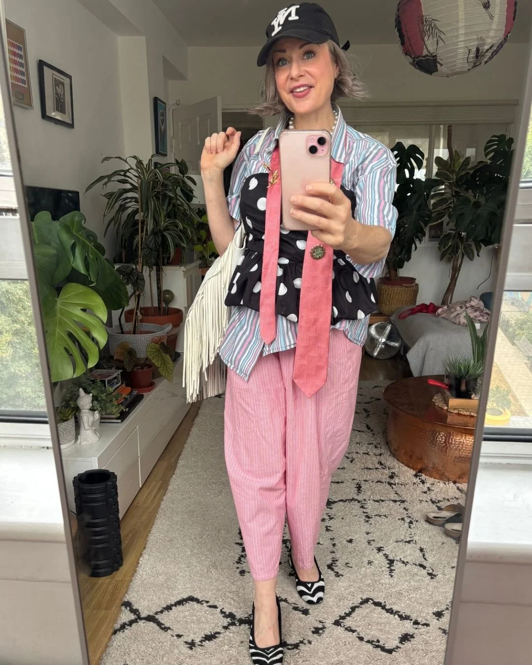 over 40 female stylist wearing stripes, polkadots and zebra mixed in one outfit