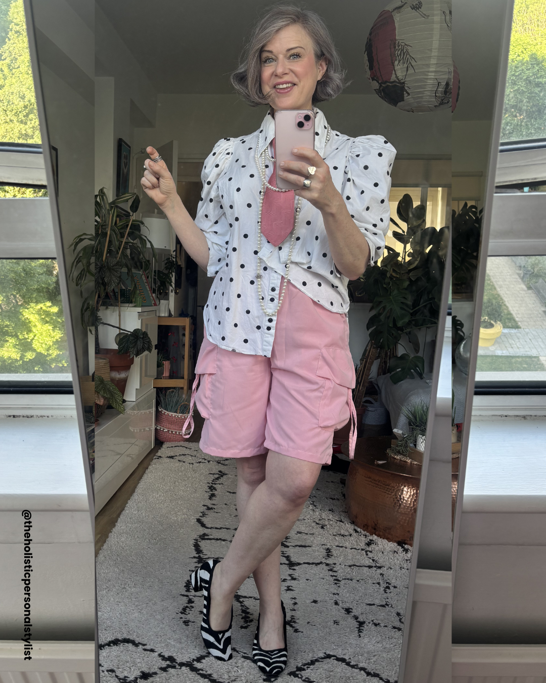 Summer outfit over 40 — white polka dot shirt, pink cargo shorts, pink tie, pearl necklace, zebra print heels — personal stylist over 40