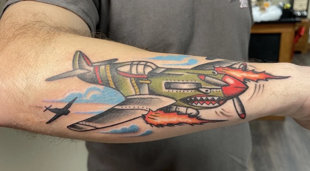 Traditional-fighter-plane-tattoo-by-Marie-Rose.jpg