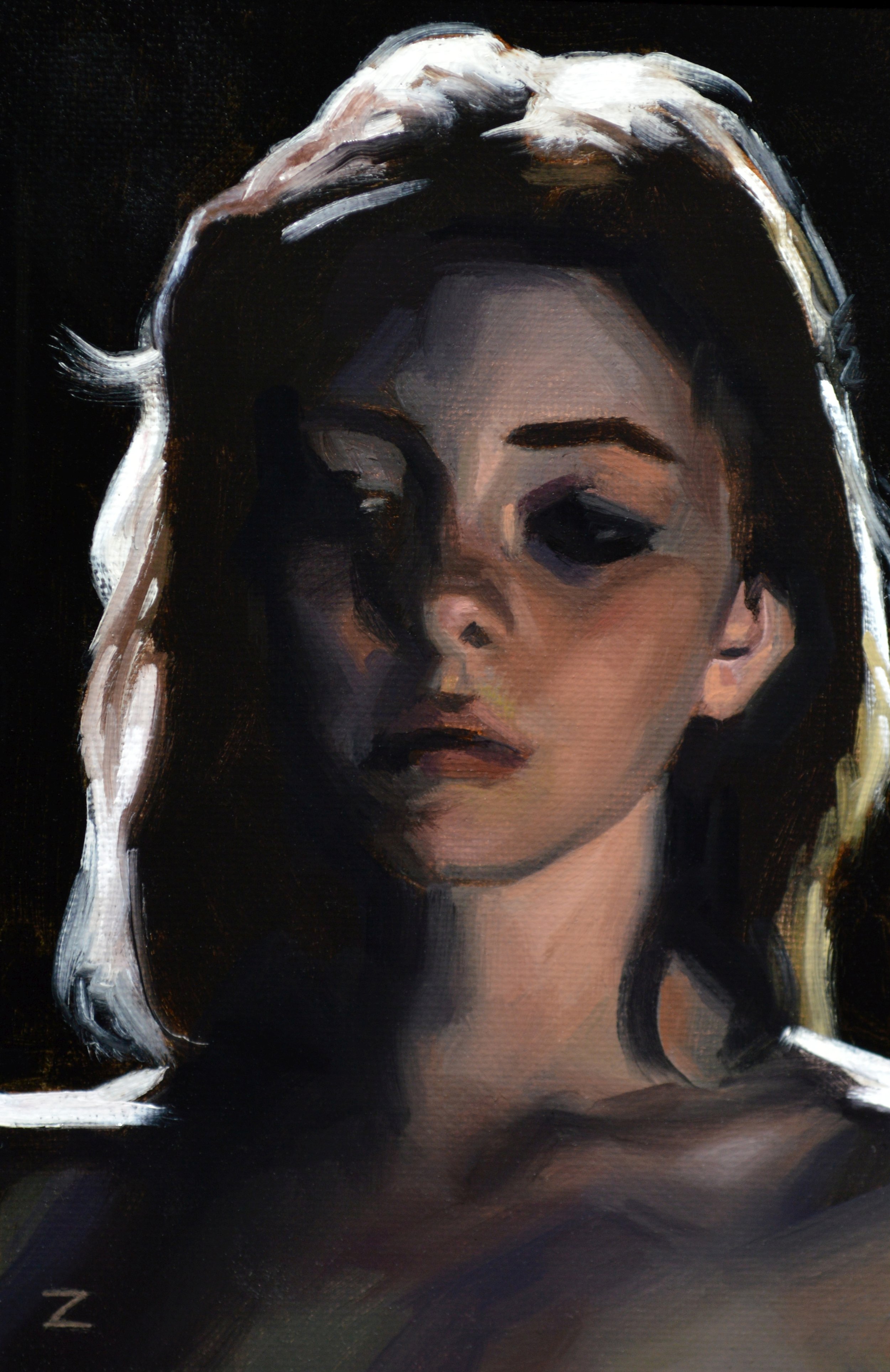 backlite portrait of a woman with somber expression