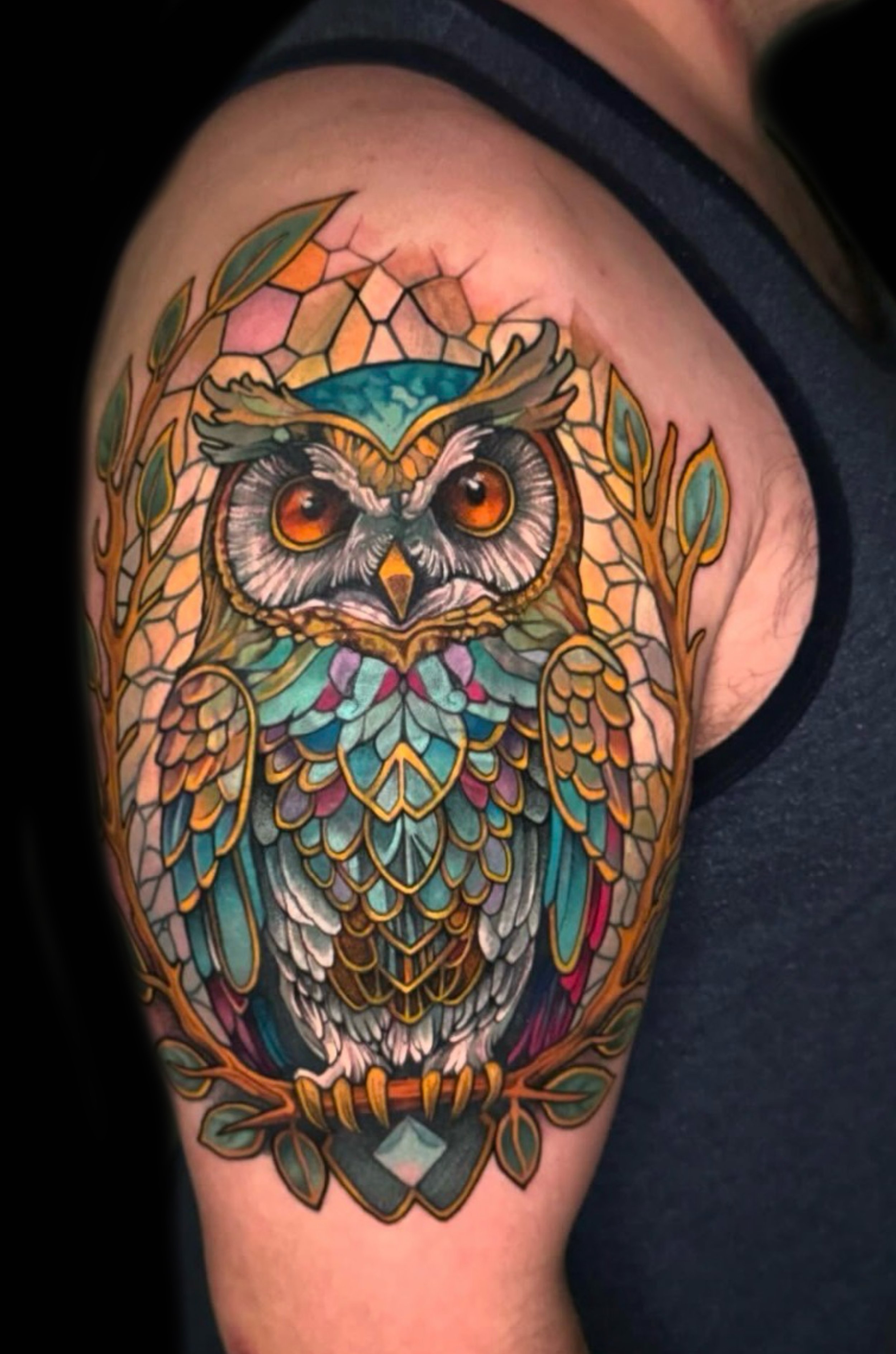 Colorful tattoo of an owl in stained glass by Richie Lucero