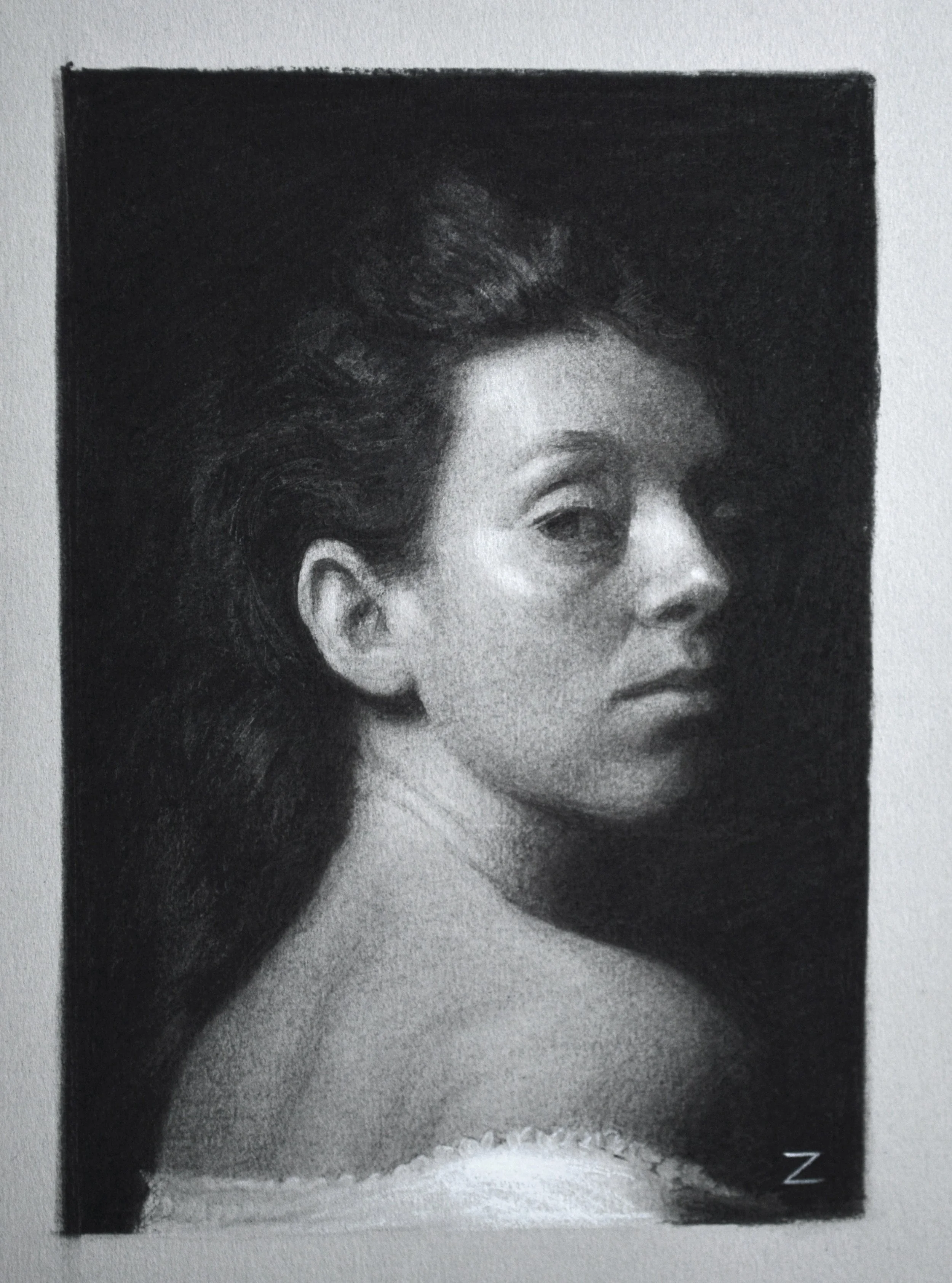 charcoal study of a woman's portrait looking over the shoulder