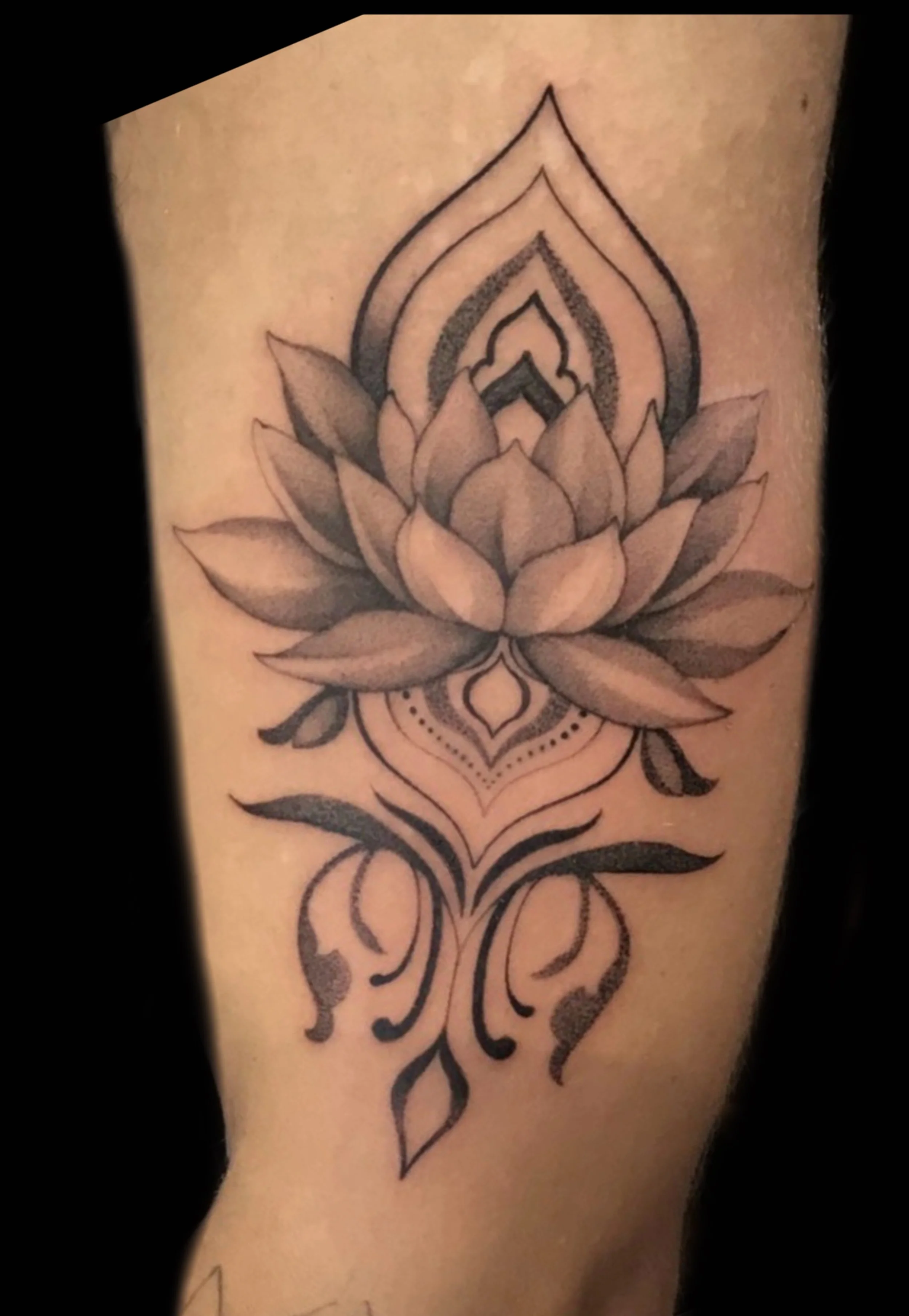 A tattoo of a lotus flower with geometric and ornamental designs by Marie Makowski