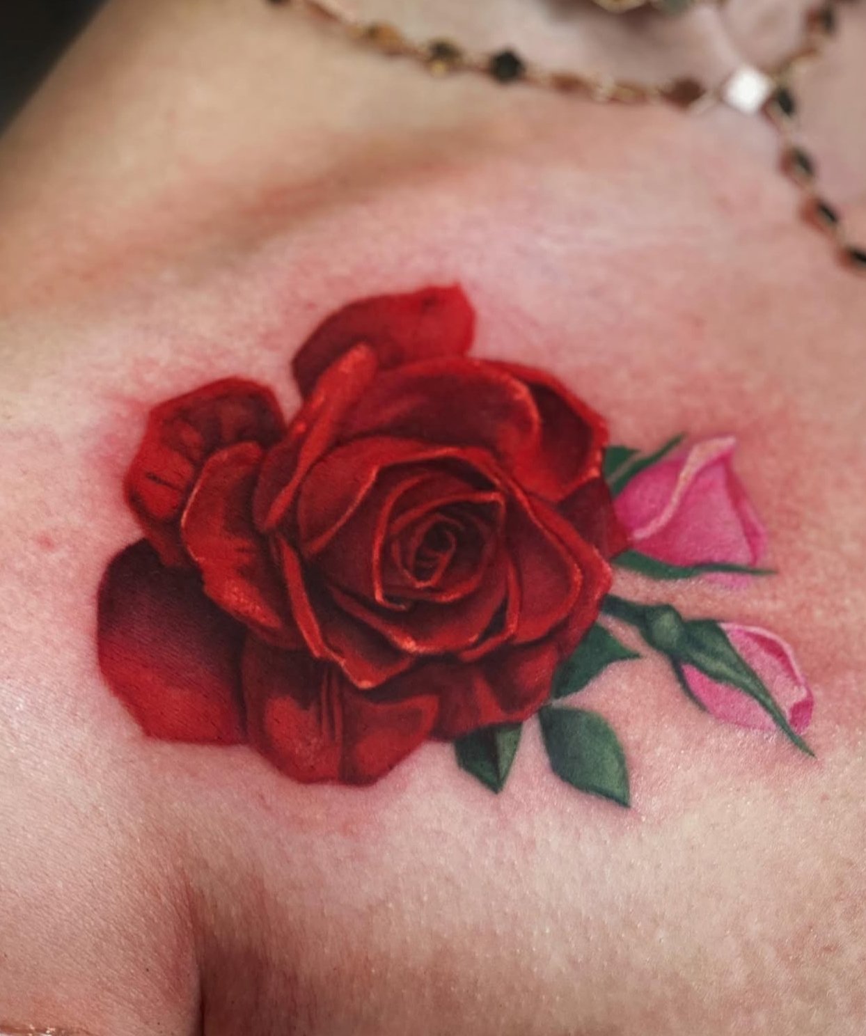 Tattoo of a red rose with pink buds by Richie Lucero