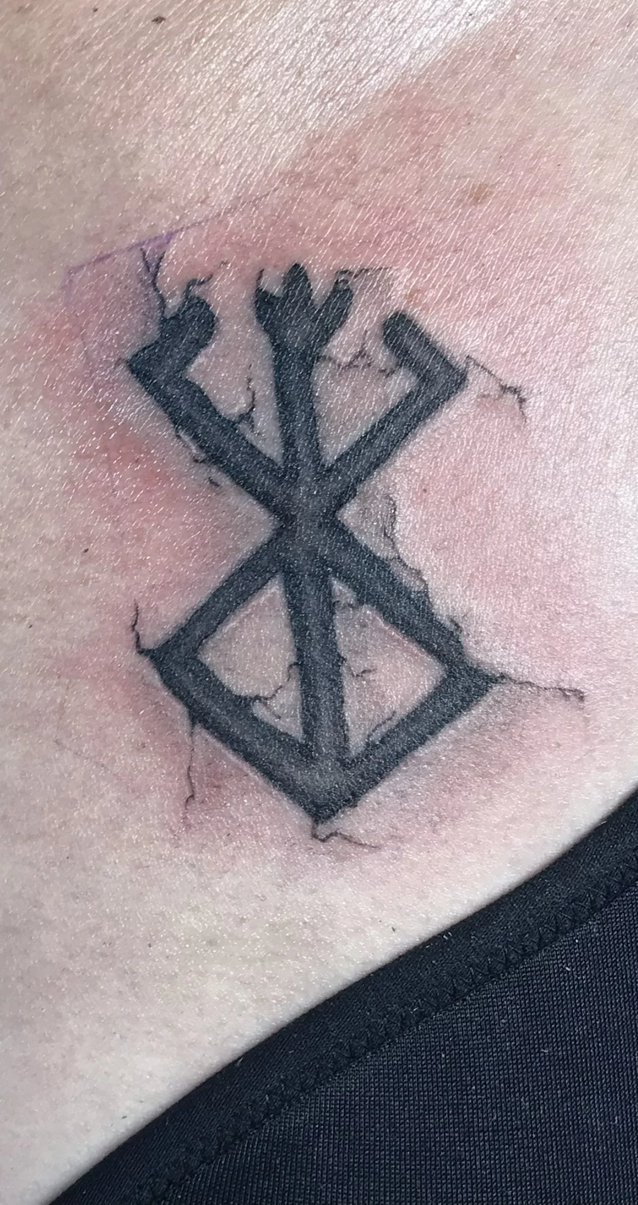 black and grey symbol tattoo