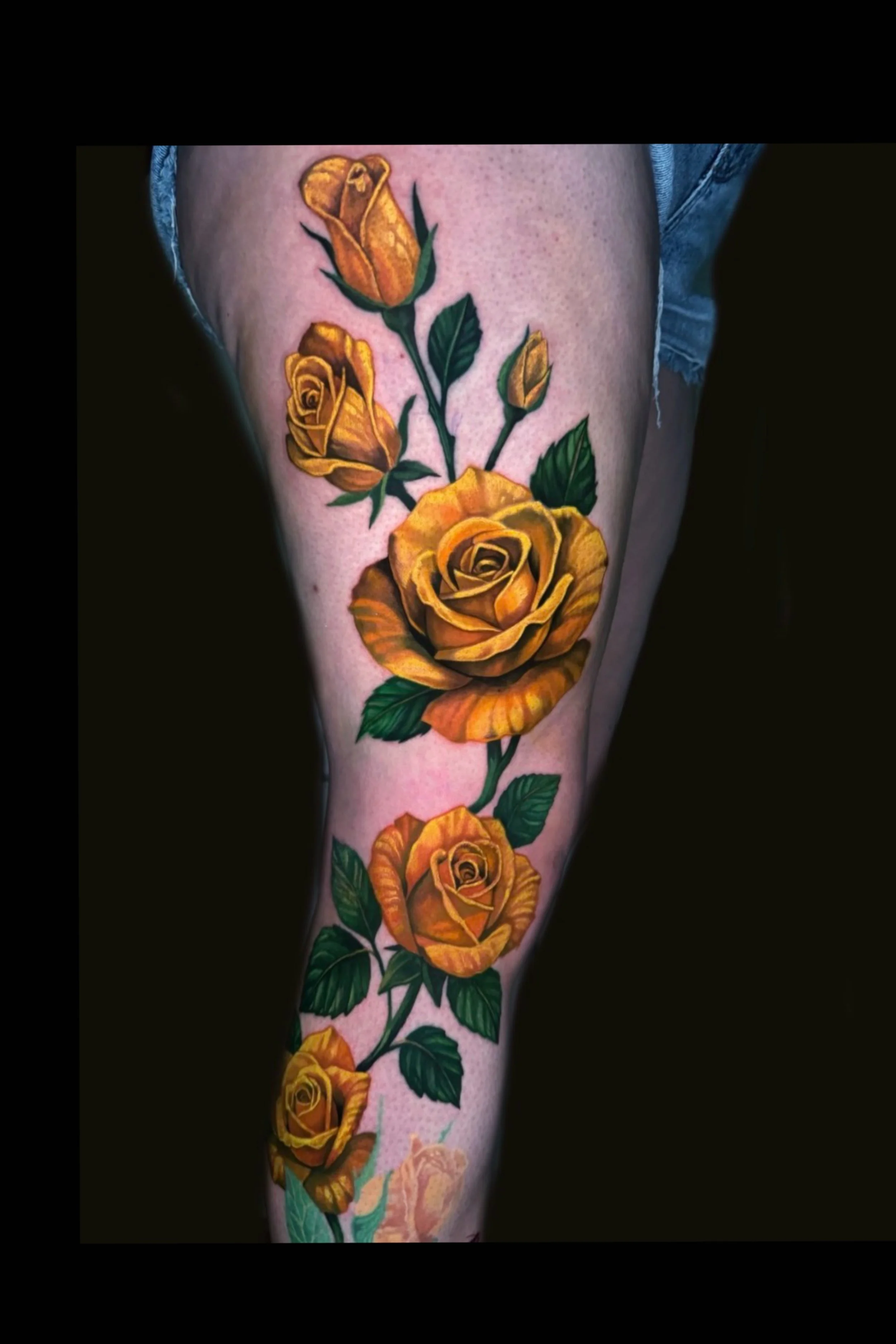 Colorful tattoo of yellow roses by Richie Lucero
