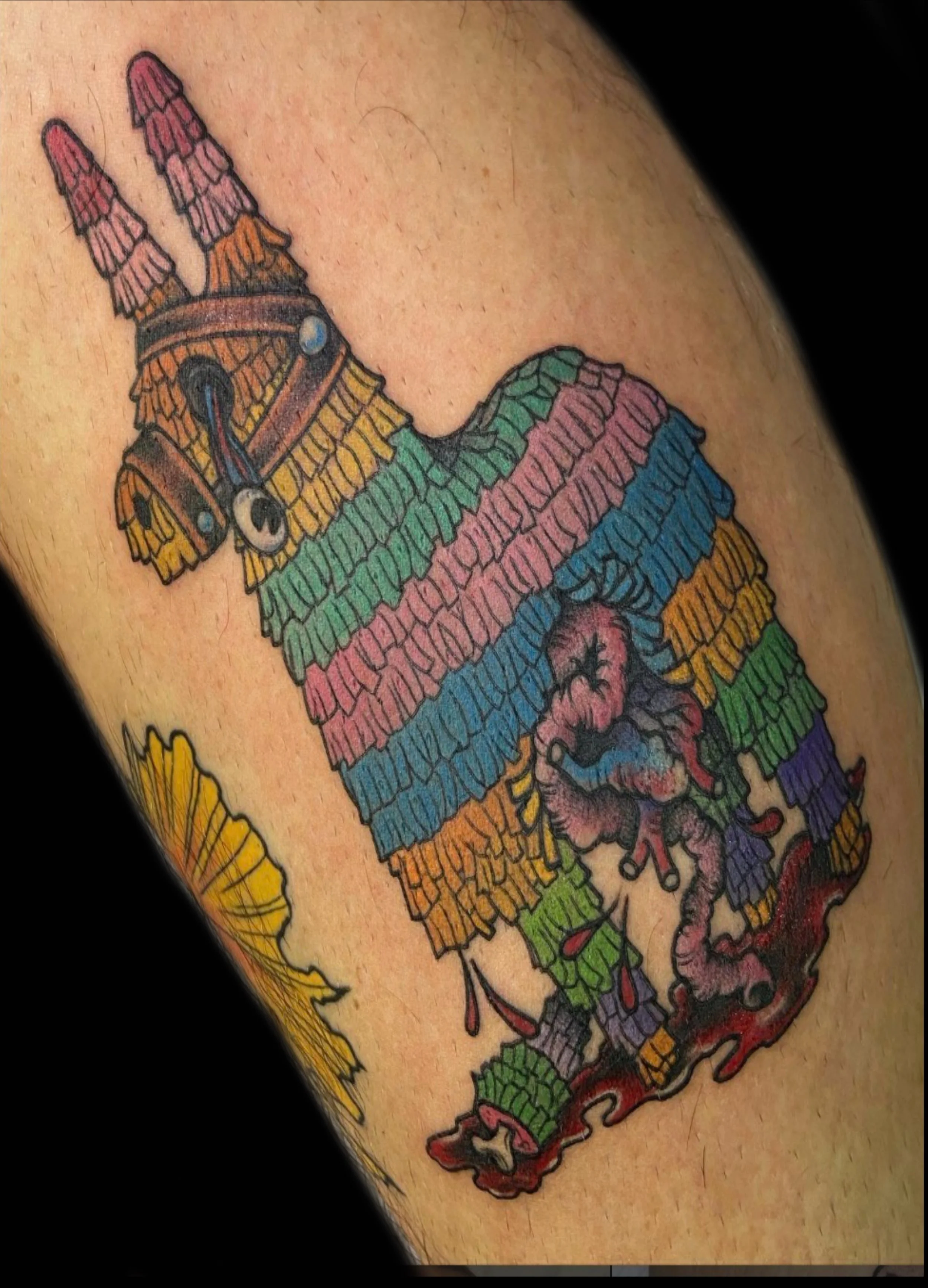 Colorful tattoo of a pinata by Sue Kidder