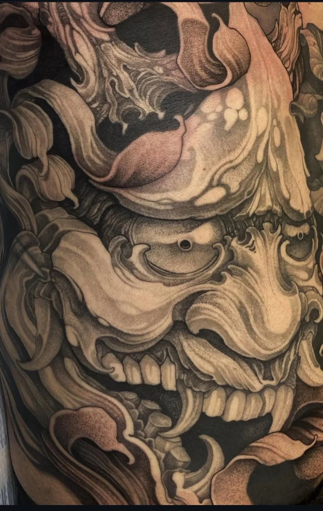  Black and grey Japanese Hannya mask tattoo by Richie Lucero