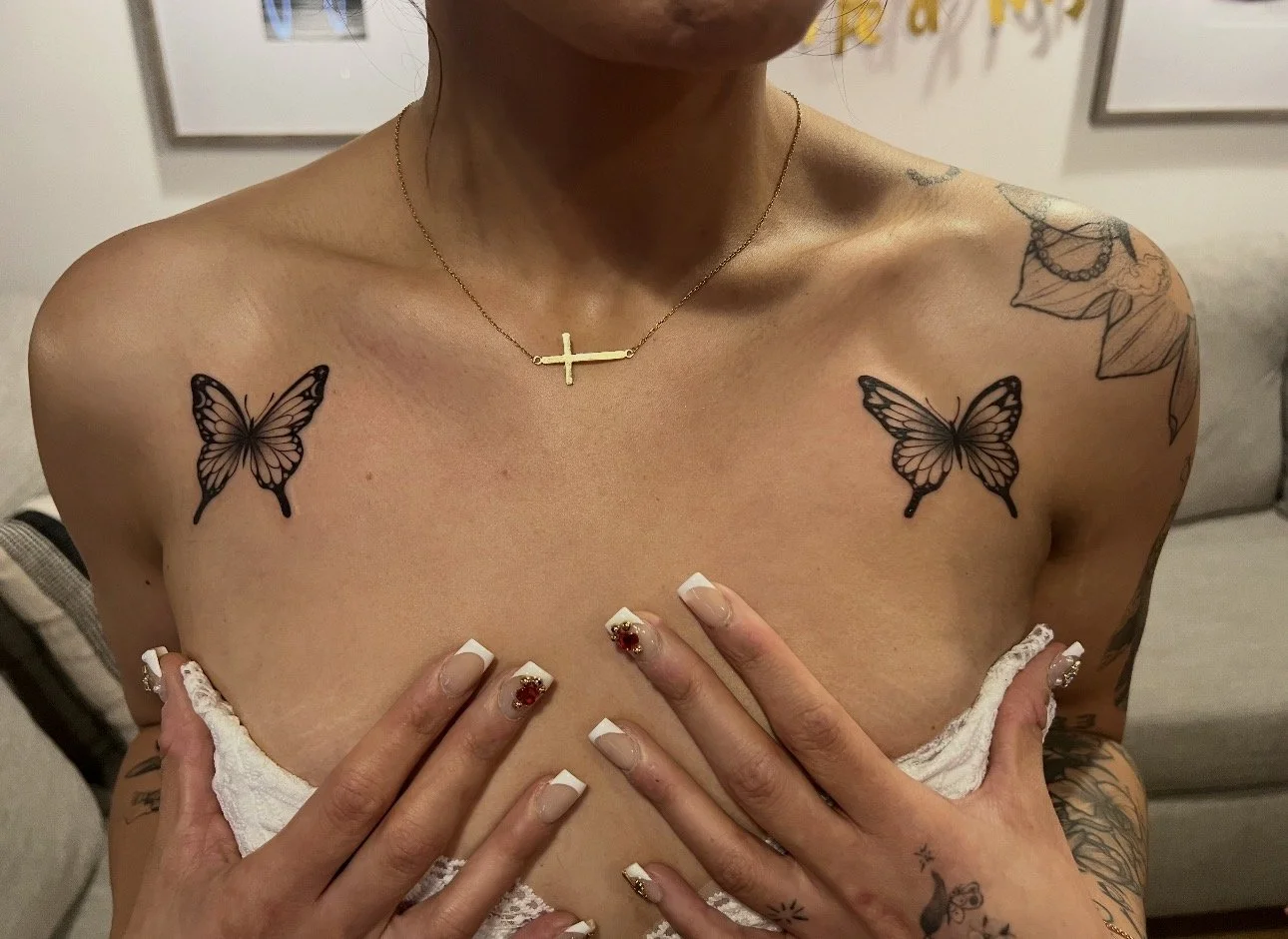Butterflies outlined in black tattooed by Telley