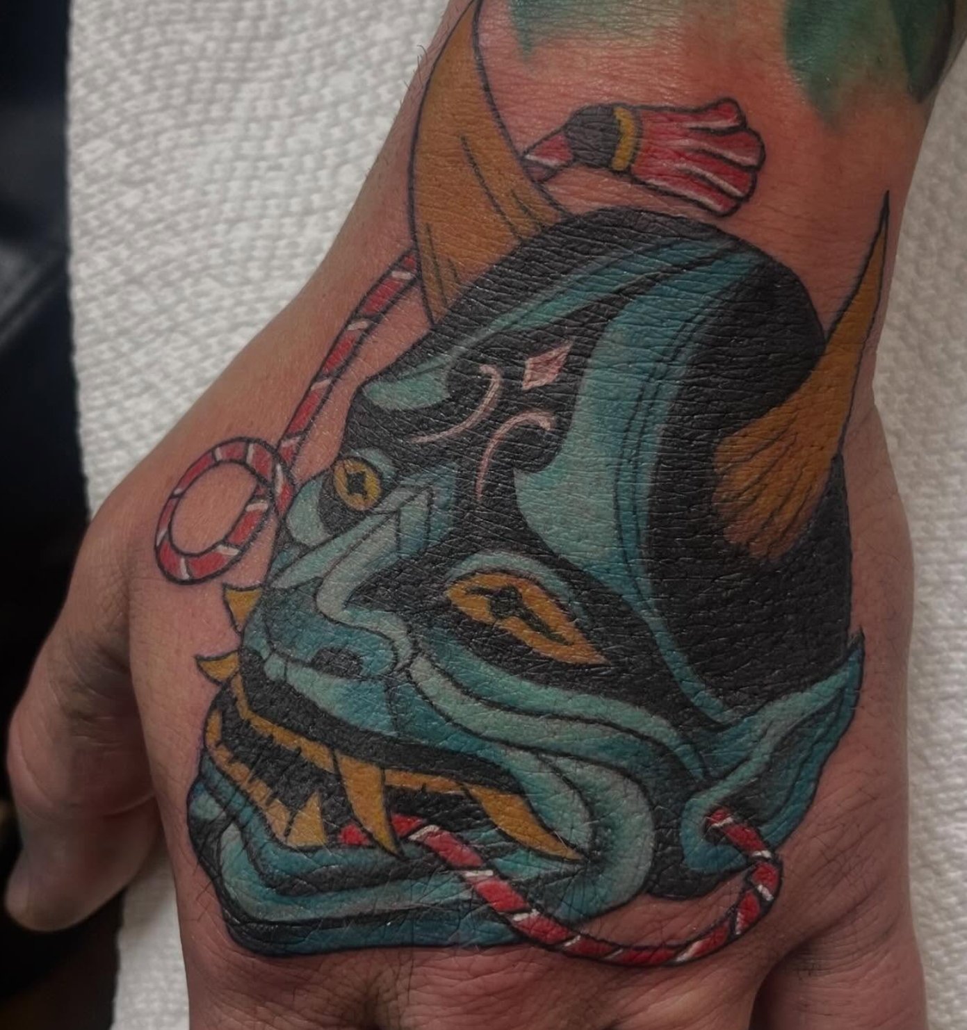 blue-Hannya-tattoo-on-hand-by-Marie-Rose.jpg