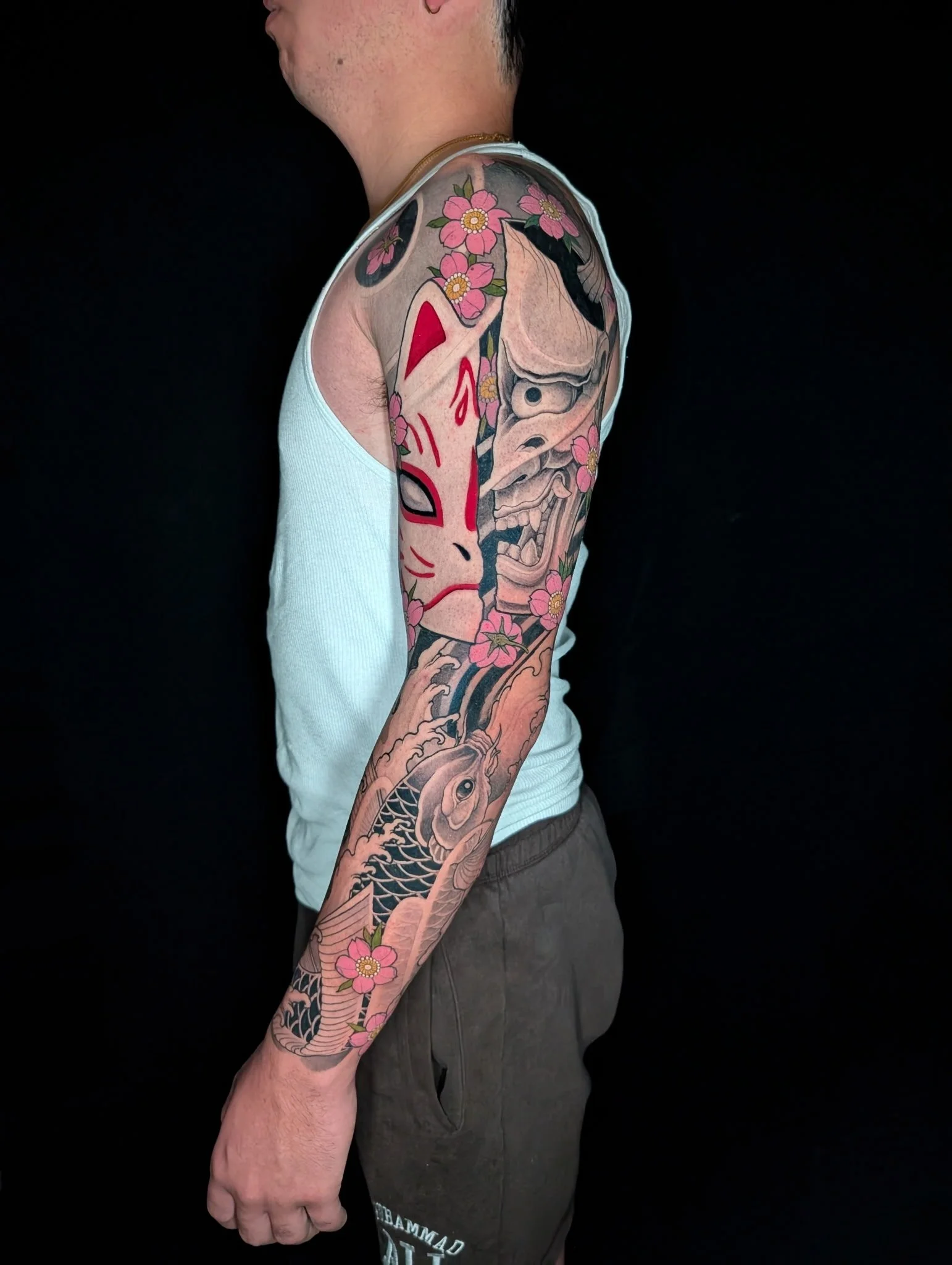 Japanese sleeve tattoo of kitsune and hannya masks and koi by Zach Yokoyama